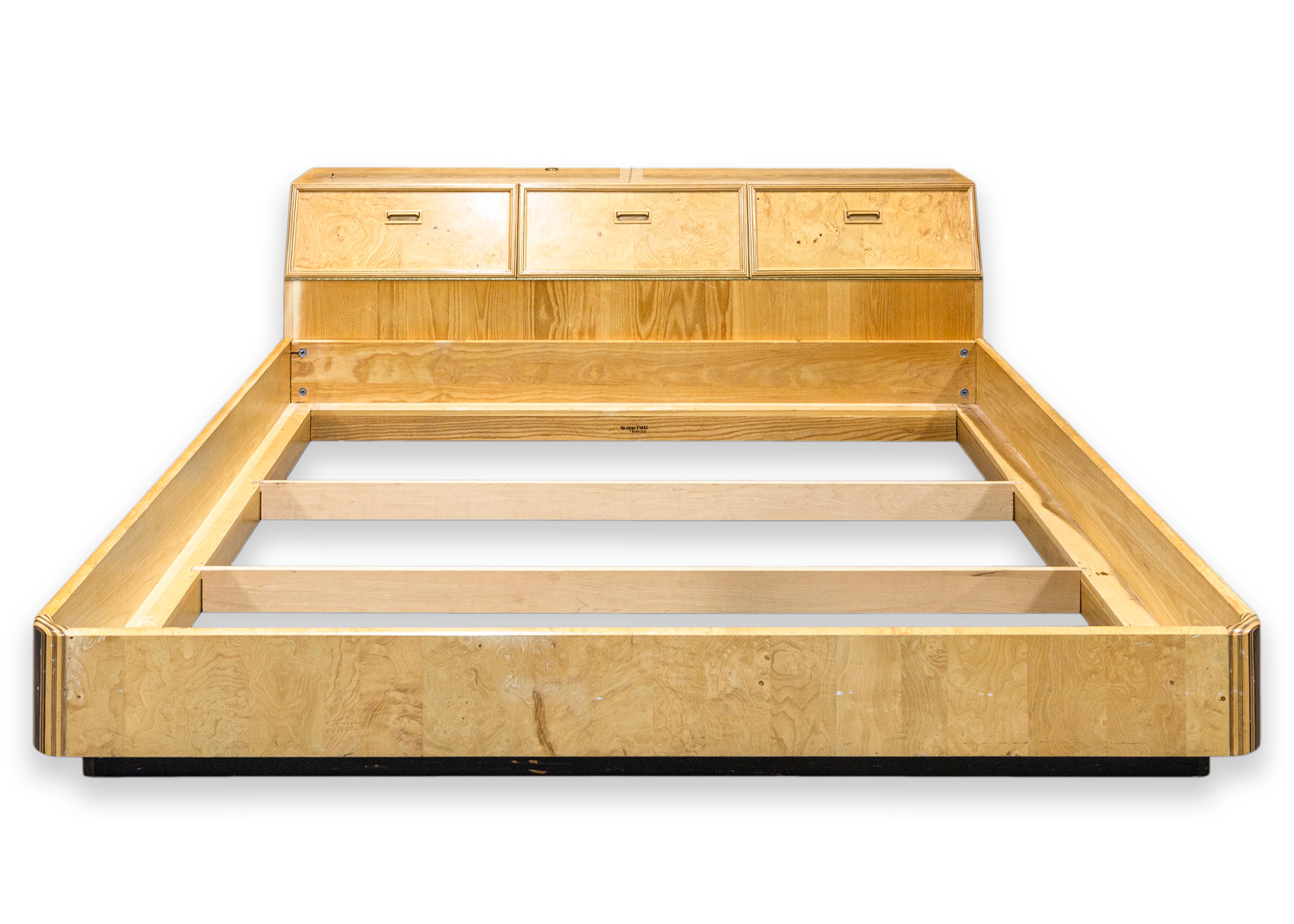 A Henredon Scene Two king size bed frame. This bed frame feature a solid ash wood construction with a mix of ash burlwood, ebony, and walnut veneers and laminates. This listing include the bed frame, the rear headboard and storage unit, as well as