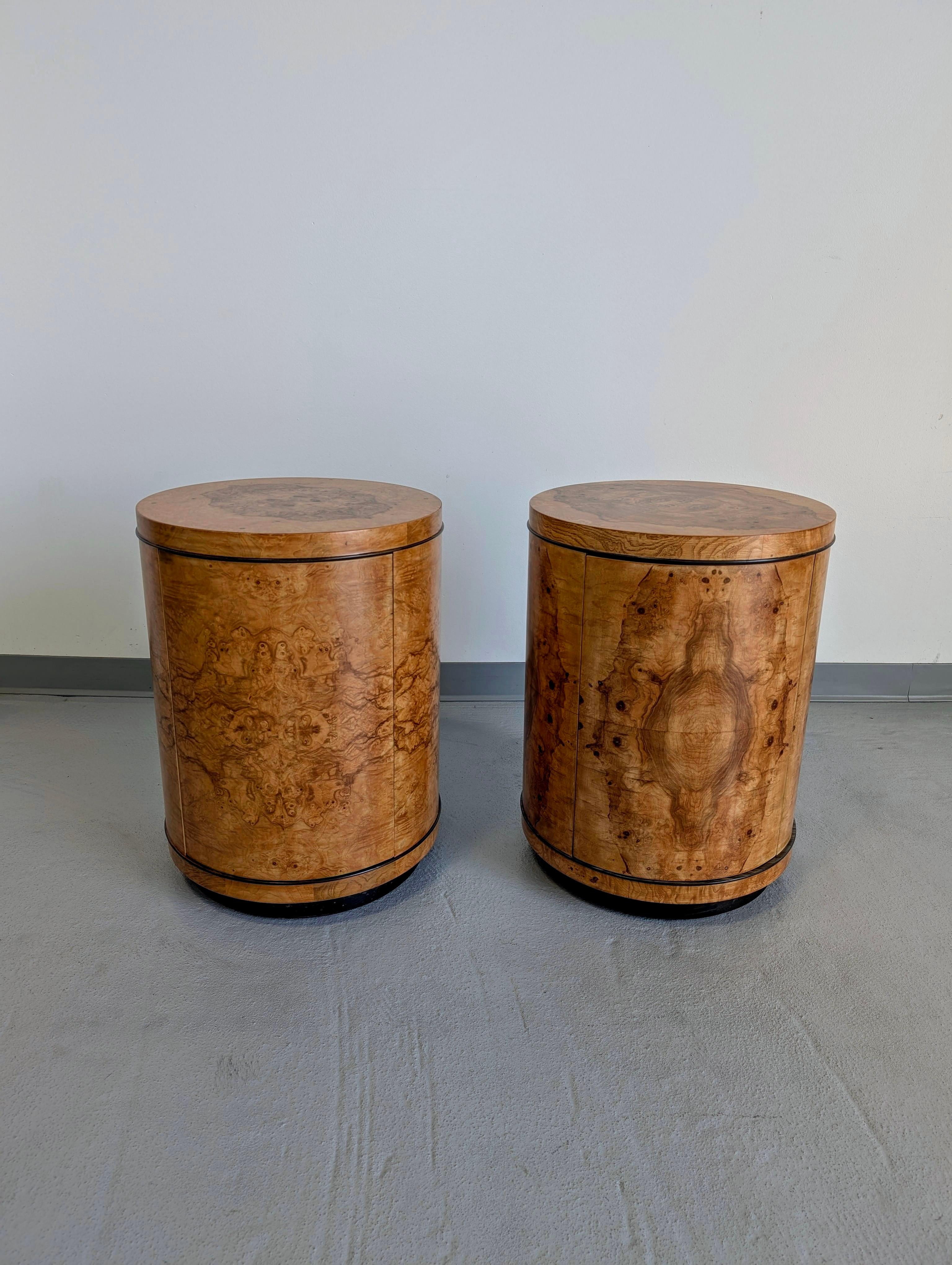 Pair of Scene II burl olive wood side tables by Henredon. The art deco inspired drum tables contain a 