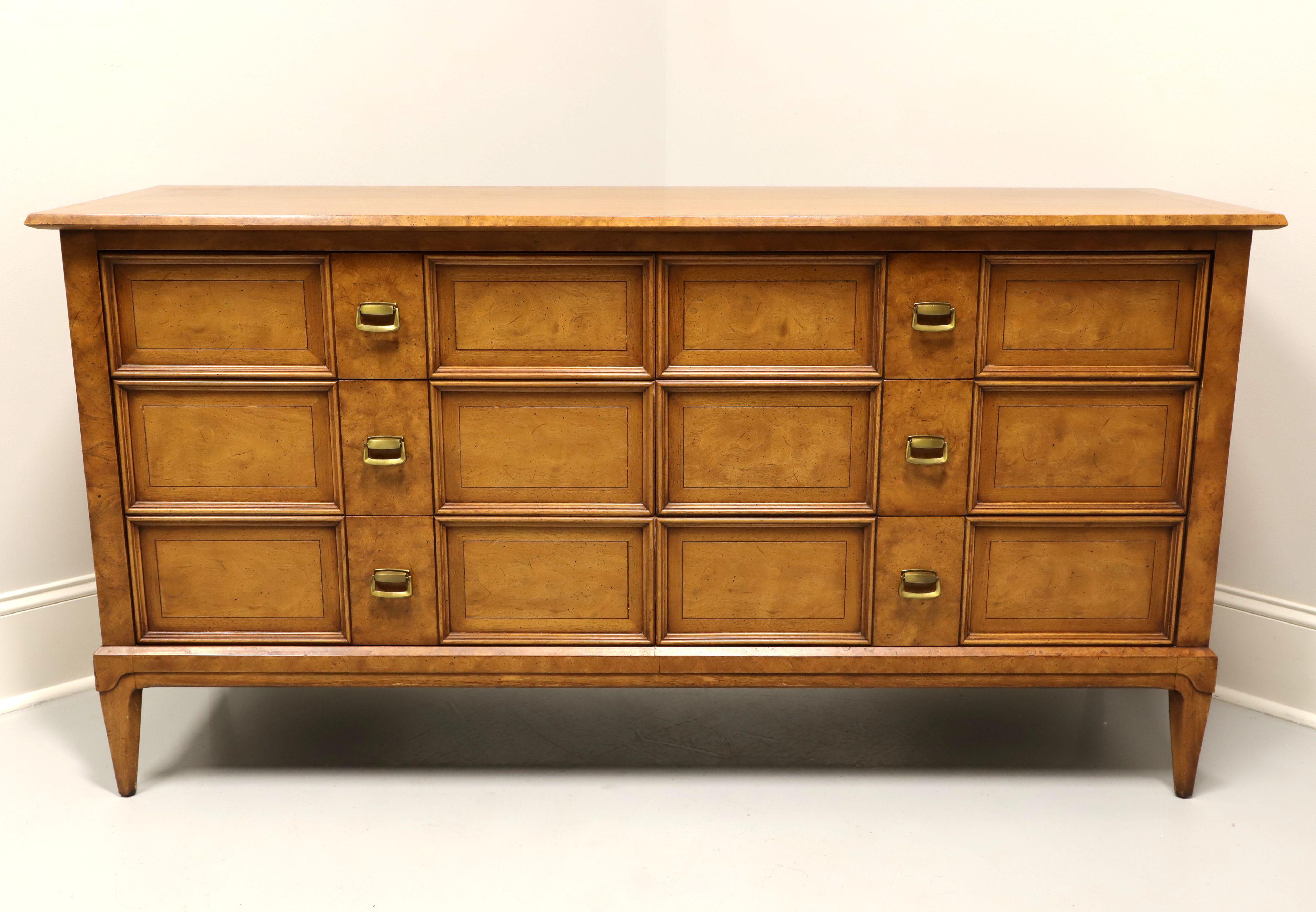 A Mid-20th Century double dresser by Henredon, from their Sequent line. Burlwood, hardwood, brass hardware, burlwood banded top, clean mid-century lines and spade feet. Features six drawers of dovetail construction, two middle drawers having a