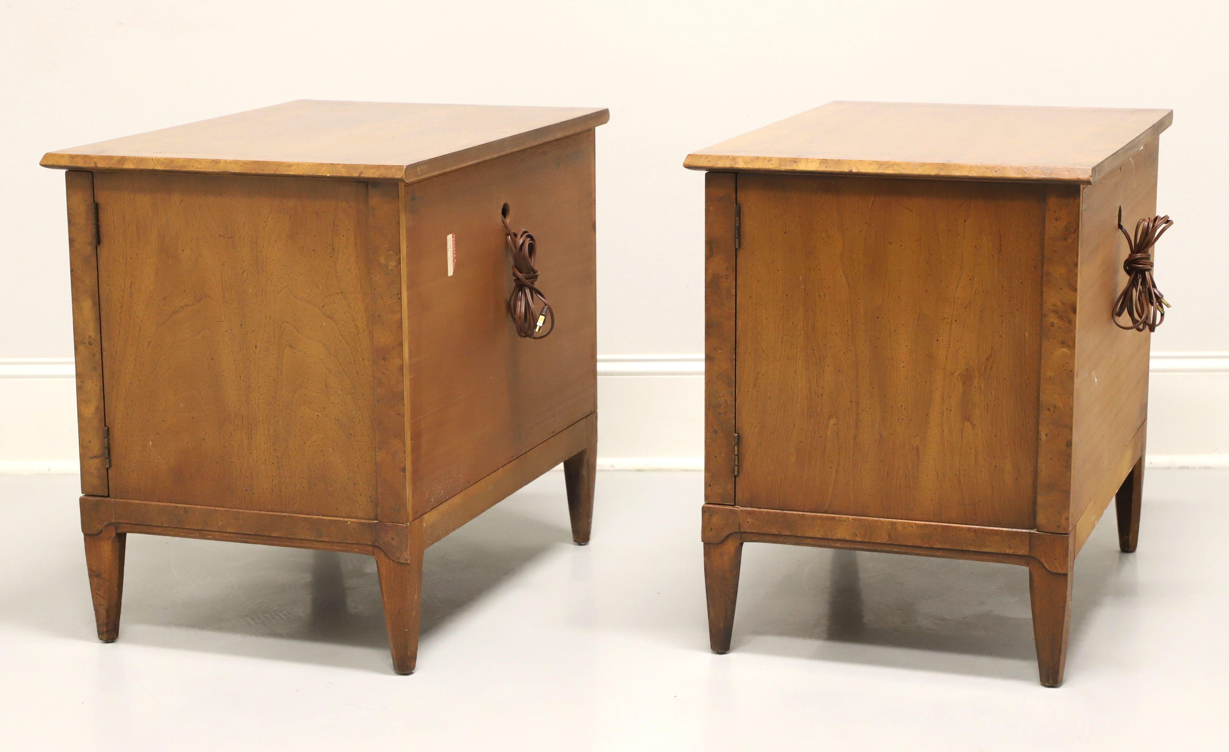 A pair of Mid-20th Century nightstands by Henredon, from their Sequent line. Burlwood, hardwood, brass hardware, burlwood banded top, clean mid-century lines and spade feet. Features a two door cabinet revealing a storage area with one adjustable