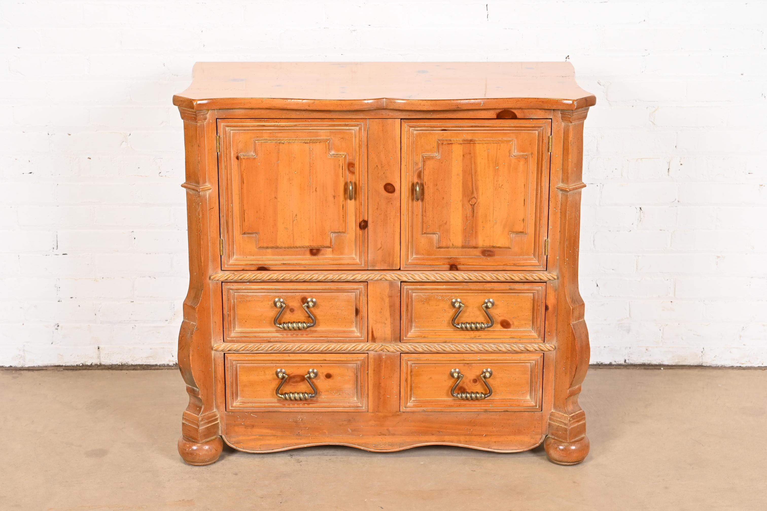 A gorgeous Spanish Baroque style bar cabinet, commode, or chest of drawers

By Henredon

USA, Late 20th Century

Carved solid pine, with original brass hardware.

Measures: 38