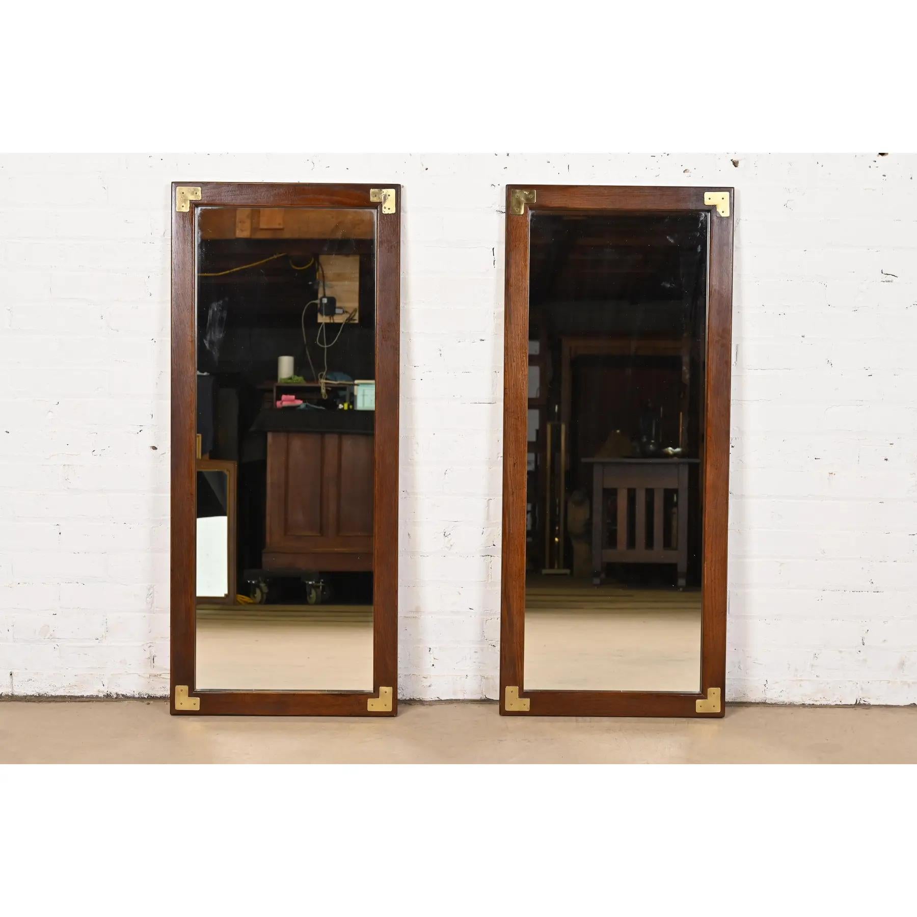 A stylish pair of Mid-Century Modern Hollywood Regency Campaign style oak and brass framed wall mirrors

In the manner of Henredon

USA, Circa 1970s

Measures: 19.5