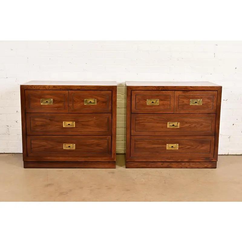 A gorgeous pair of Mid-Century Modern Campaign style nightstands or bachelor chests

In the manner of Henredon

By Dixie

USA, Circa 1970s

Oak, with original brass hardware.

Measures: 32