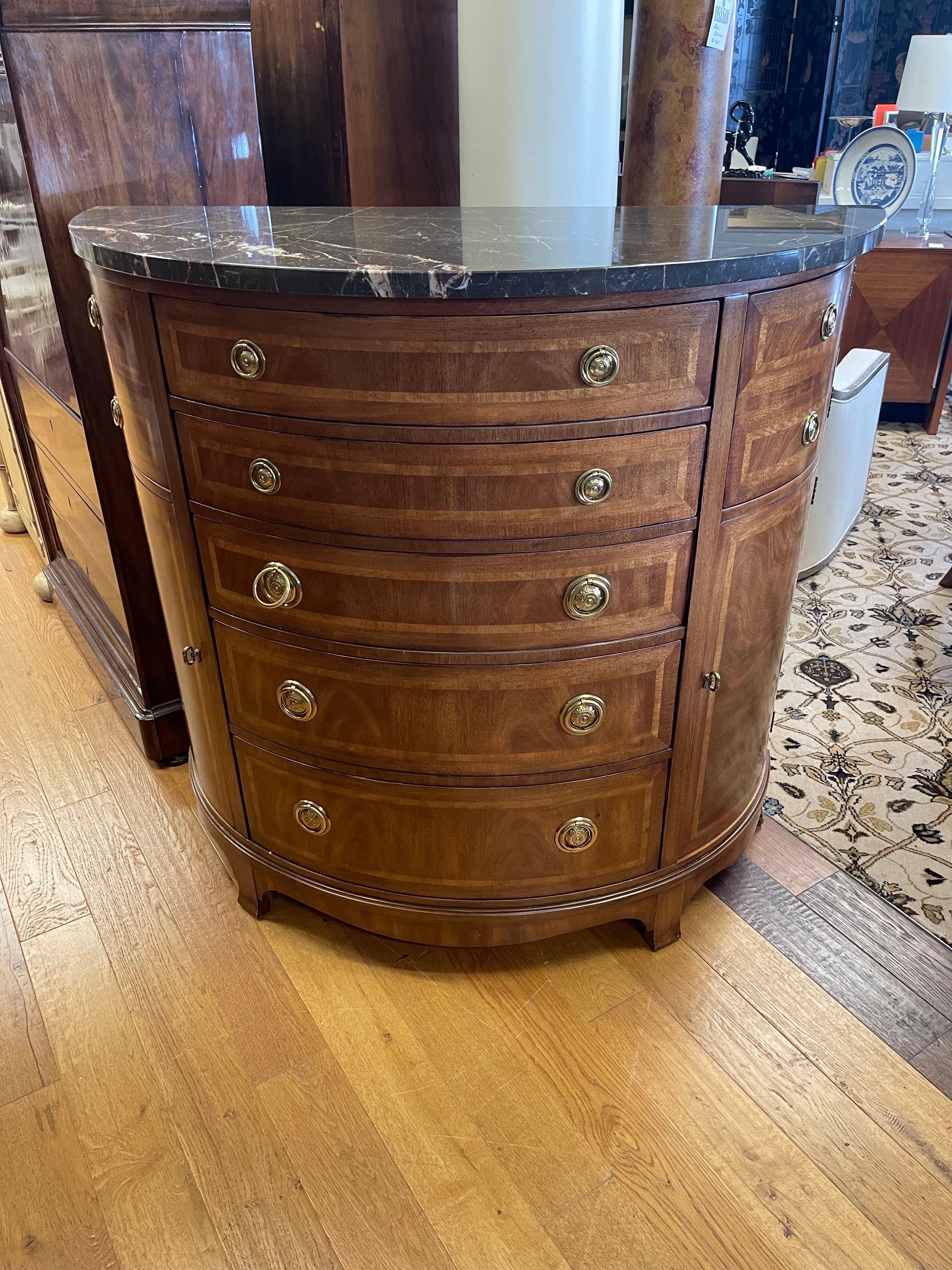 This exquisite and substantial Henredon signed bow front dresser has generous storage what with five large drawers and four cabinet doors. Isn't it time to elevate your living space? Features marble top and brass hardware.