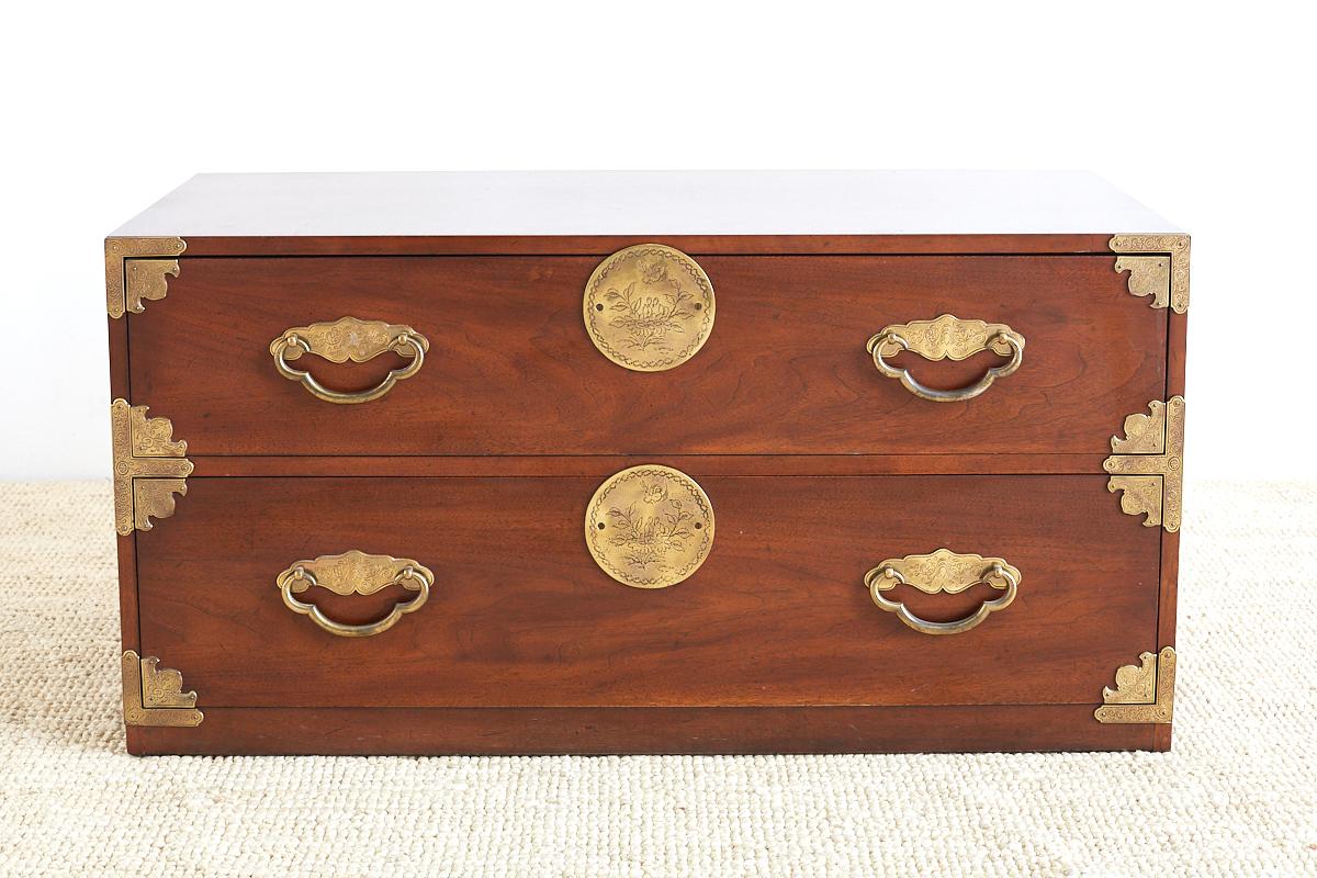 Midcentury tansu style mahogany campaign chest by Henredon. Features a low, two drawer design with etched brass hardware and handles decorated in an Asian motif. Heavy and solid with a lovely profile.