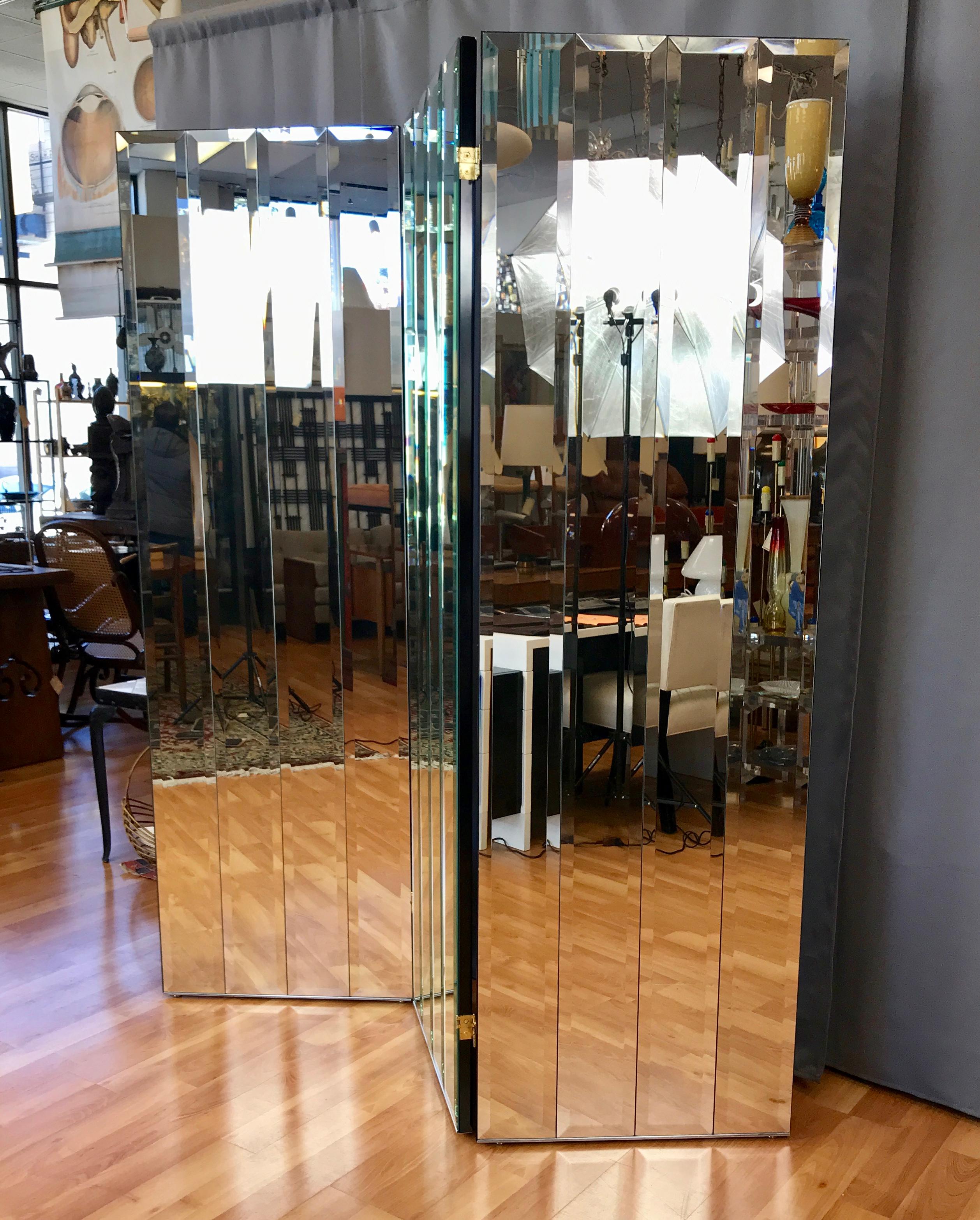 A super glam 1970s Henredon three-panel beveled mirror room divider.

Each very heavy solid wood panel features four narrow rectangular beveled mirrors, with the entire piece providing a dazzling array of dynamic reflections. Backs and edges