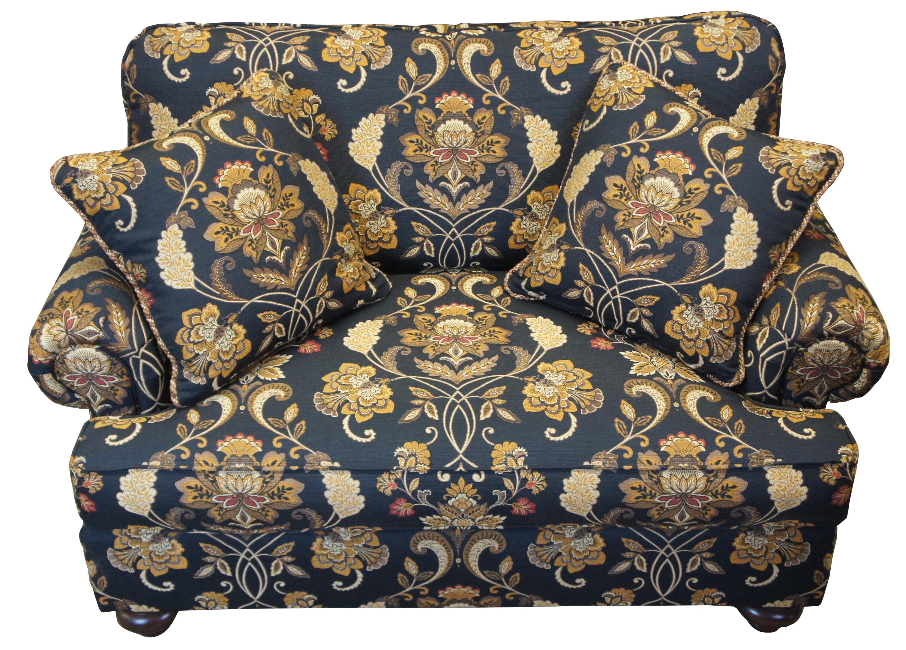 Henredon upholstery collection navy blue and gold floral sofa. Features Natchez finish with rolled arms and throw pillows. Product # H2000-S. Measures: 58”.
 