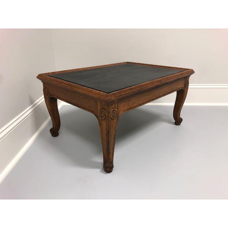 An accent table by Henredon from their Town & Country Collection. French Country style with scroll feet. Solid Oak with a distressed finish. Removable slate top. Made in the USA in the late 20th century.

Style # 40-2100

Measures: 22 W 30 D 15