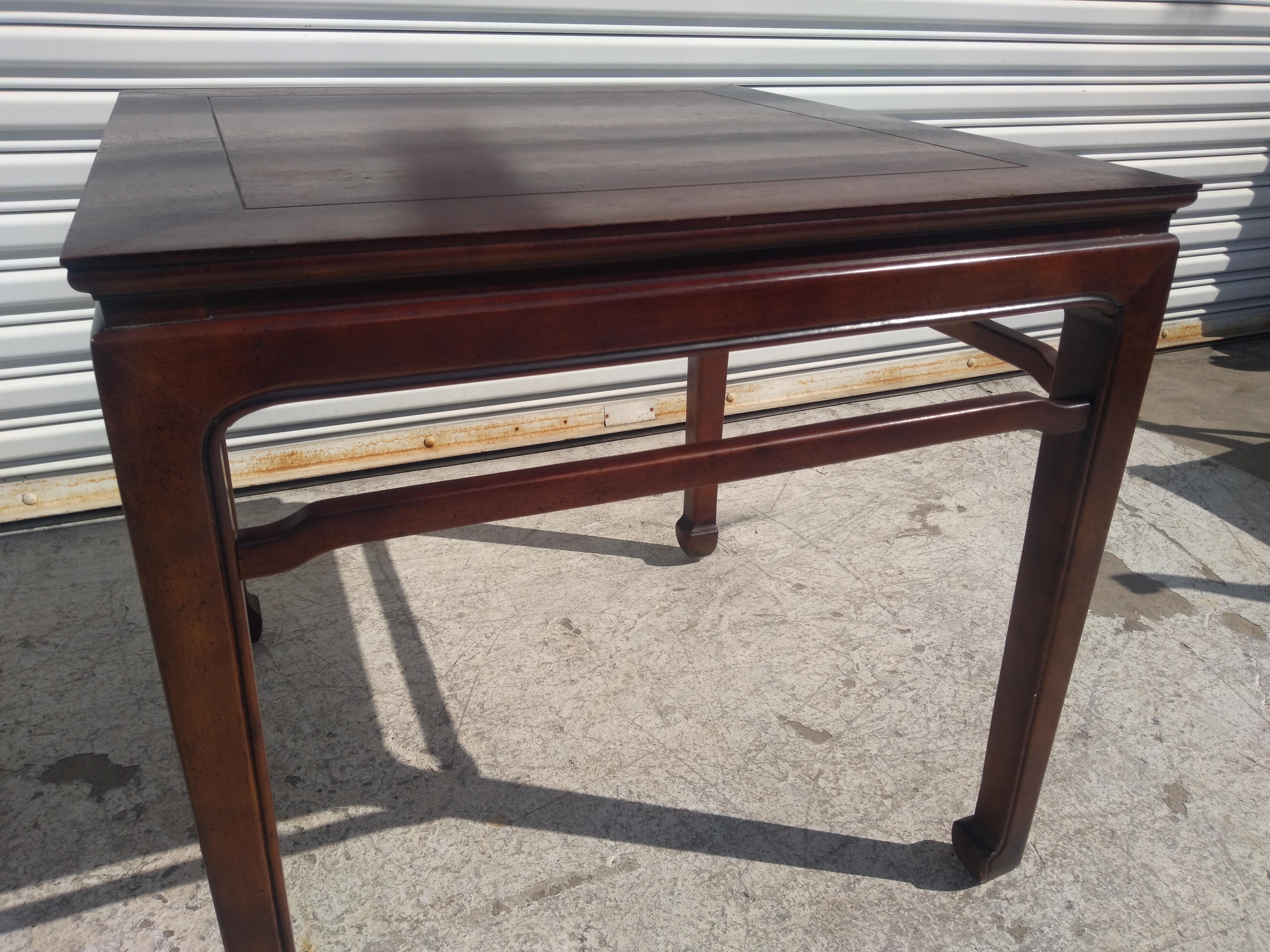 This Henredon side table is made of solid walnut. It's made in the chinoiserie ming style.
It has hoofed feet and humpback stretches for added stability. 