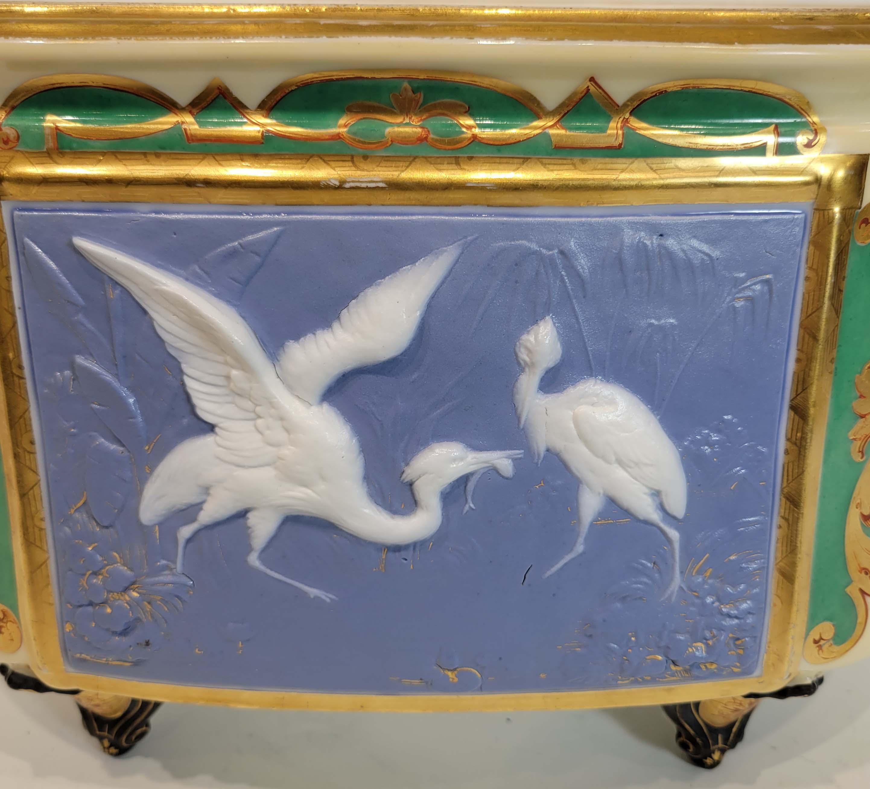 This is a rare Japonisme porcelain jardinier/planter by designer Henri Ardant, made for Limoges Porcelain Manufactory. Beautifully decorated in Japonisme style. Pate-sur-pate cranes and hound handles. In good condition, small chip on the interior of