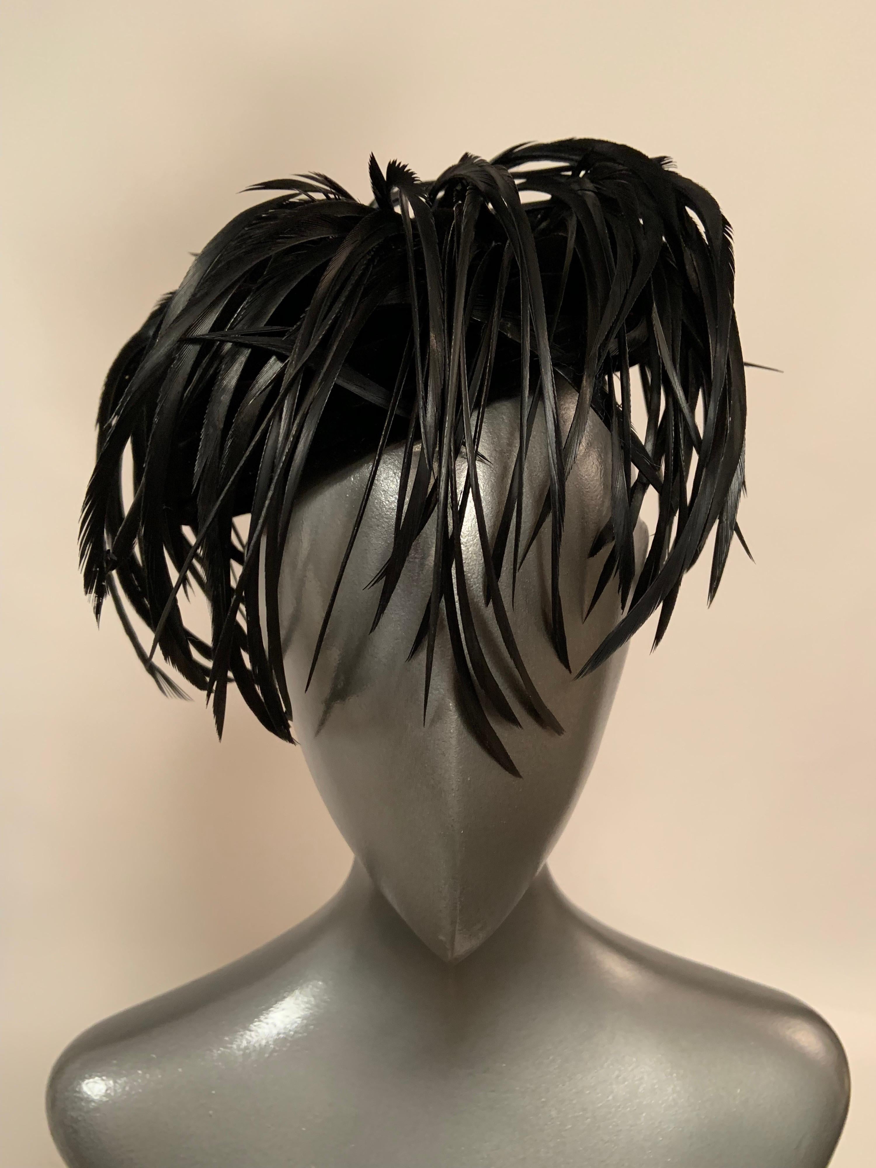 This is one of those very chic accessories that adds instant glamour to your evening look. The black velvet hat swirls from the brim to the center of the hat and then the feathers swirl over the velvet in the same circular motion, dipping over the