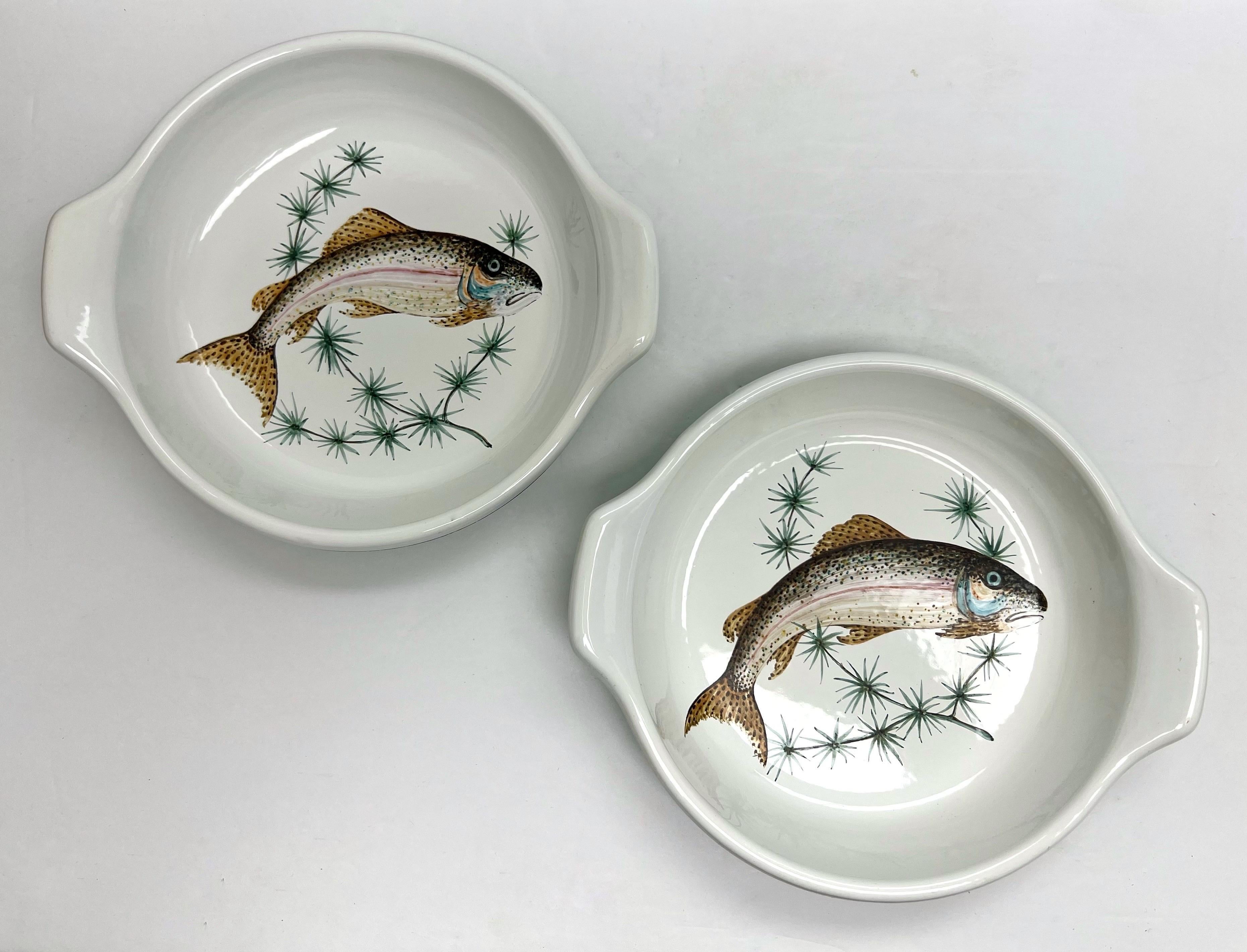 A pair of enameled dishes with hand painted decoration.  Made in Italy for Henri Bendel. 