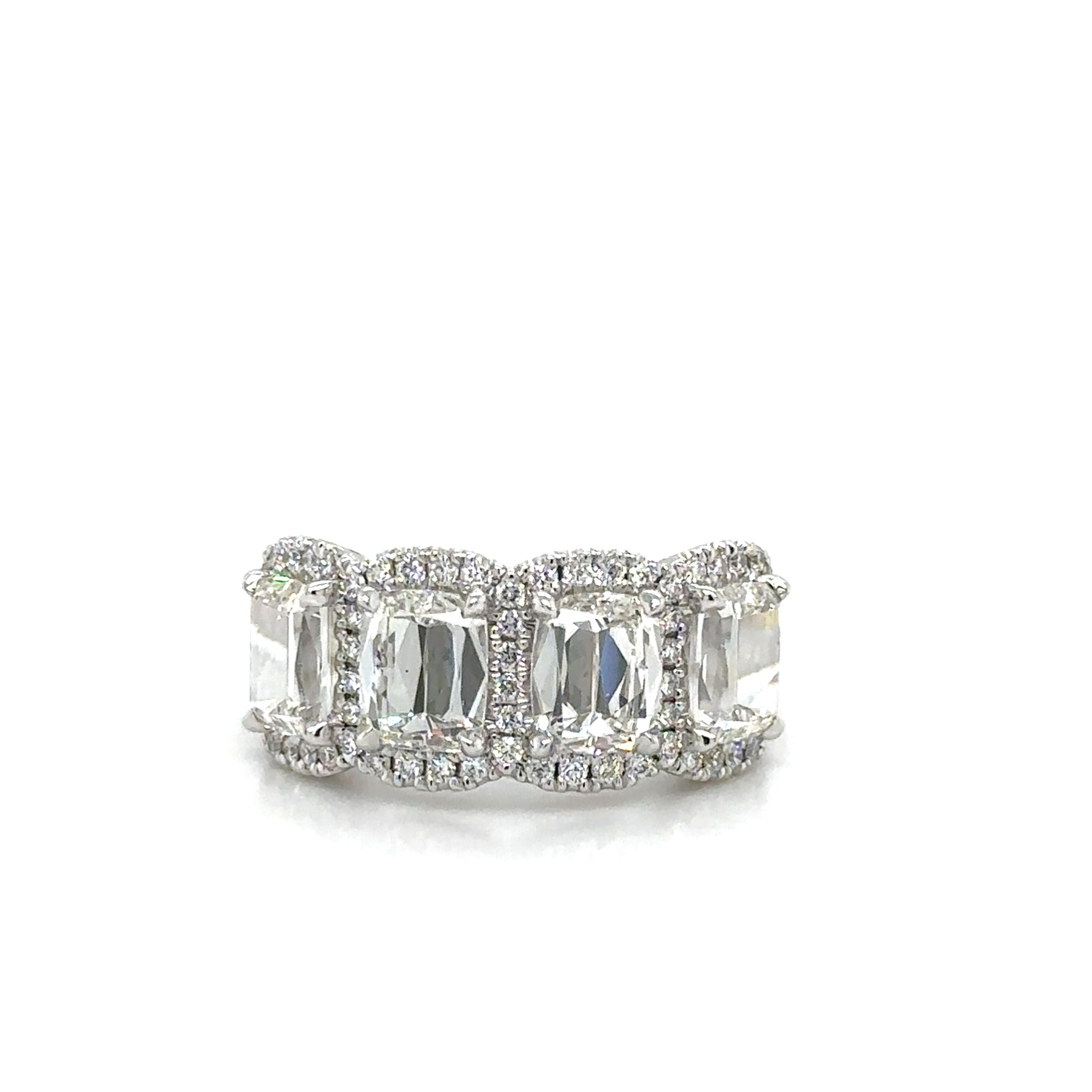 This stunning anniversary ring features a total of 4.43 carats of natural earth-mined sparkling cushion cut diamonds, all GIA certified for quality and authenticity. The matching four stone band design adds a touch of elegance and symmetry to this