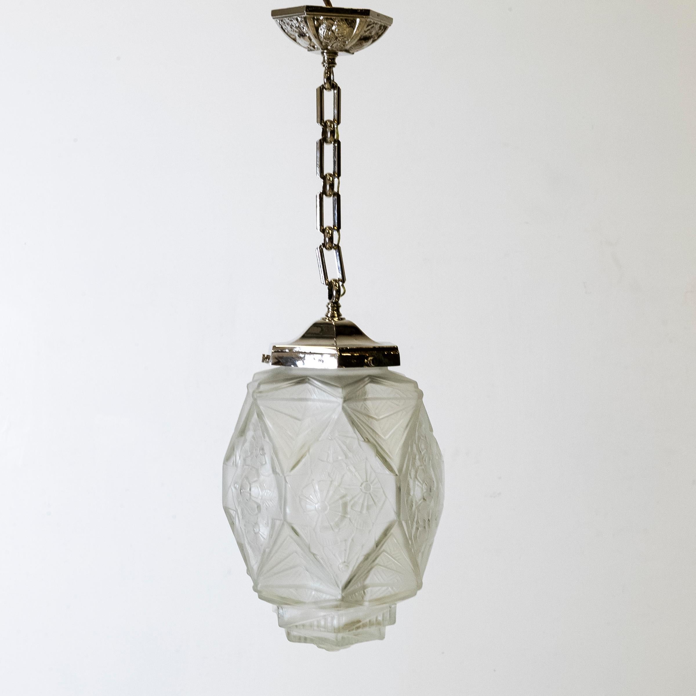 A very pretty French Art Deco Pendant light with pressed and moulded glass etched with florals and stylised geometric shapes.
Known for working with opaque glass and delicate forms, Jean Gauthier (EJG), was a renowned light designer at the height of