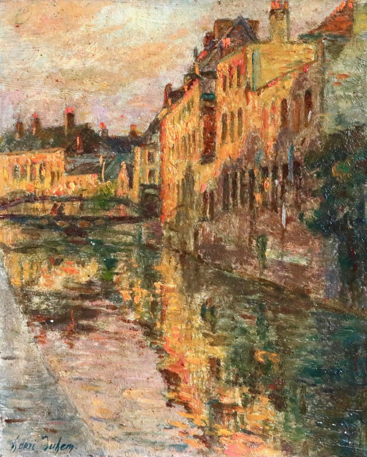 A beautiful painting of Bruges - the buildings on the water's edge being lit up by the setting sun. Oil on panel. Signed lower left and dated 1918 verso. This painting is not currently framed but a suitable frame can be sourced if