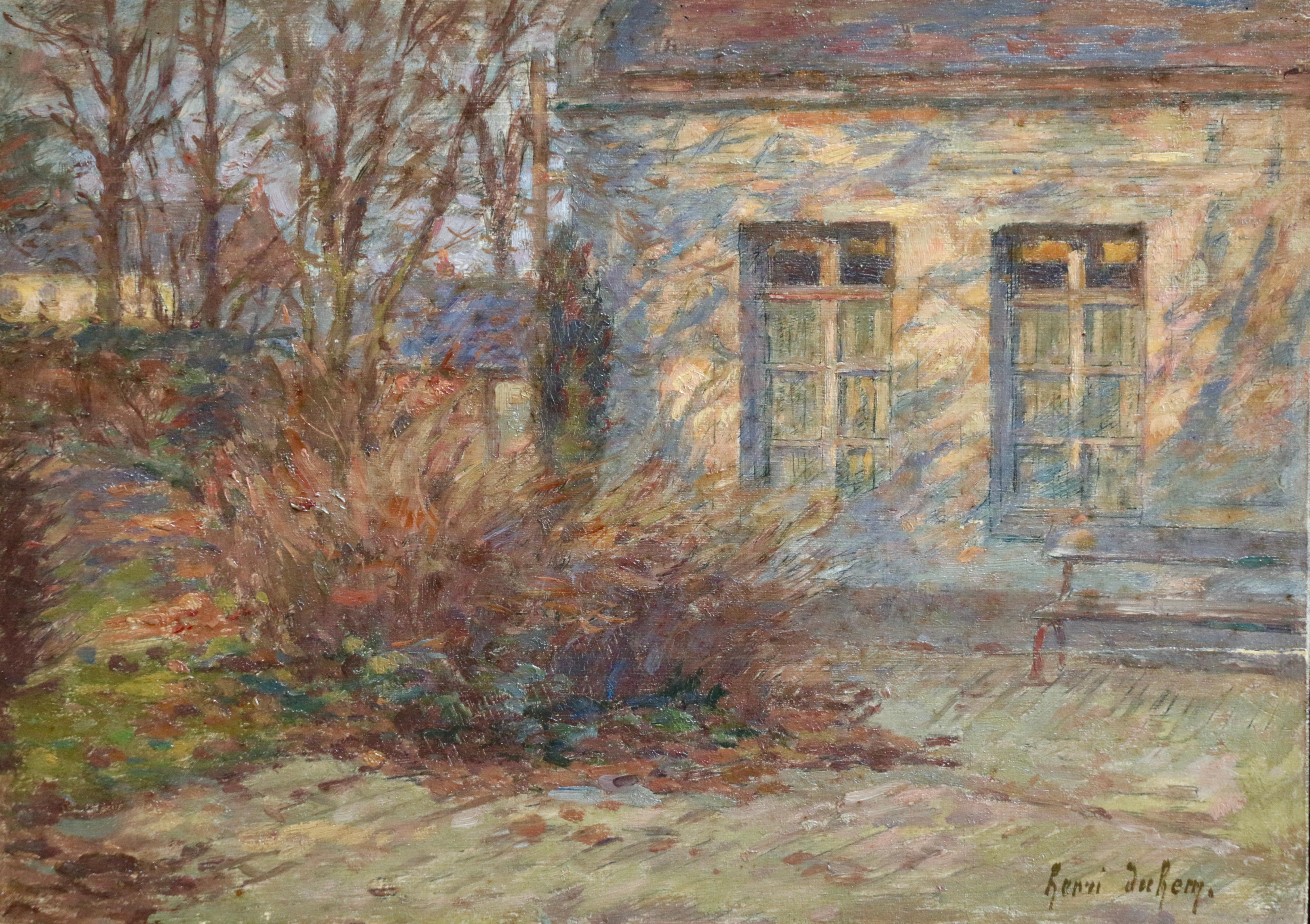 Signed impressionist oil on panel landscape by French painter Henri Duhem. The piece depicts a view of a garden beside a house in autumn. The leaves if the trees are turning shades brown and orange. The sun is setting behind the painter and the
