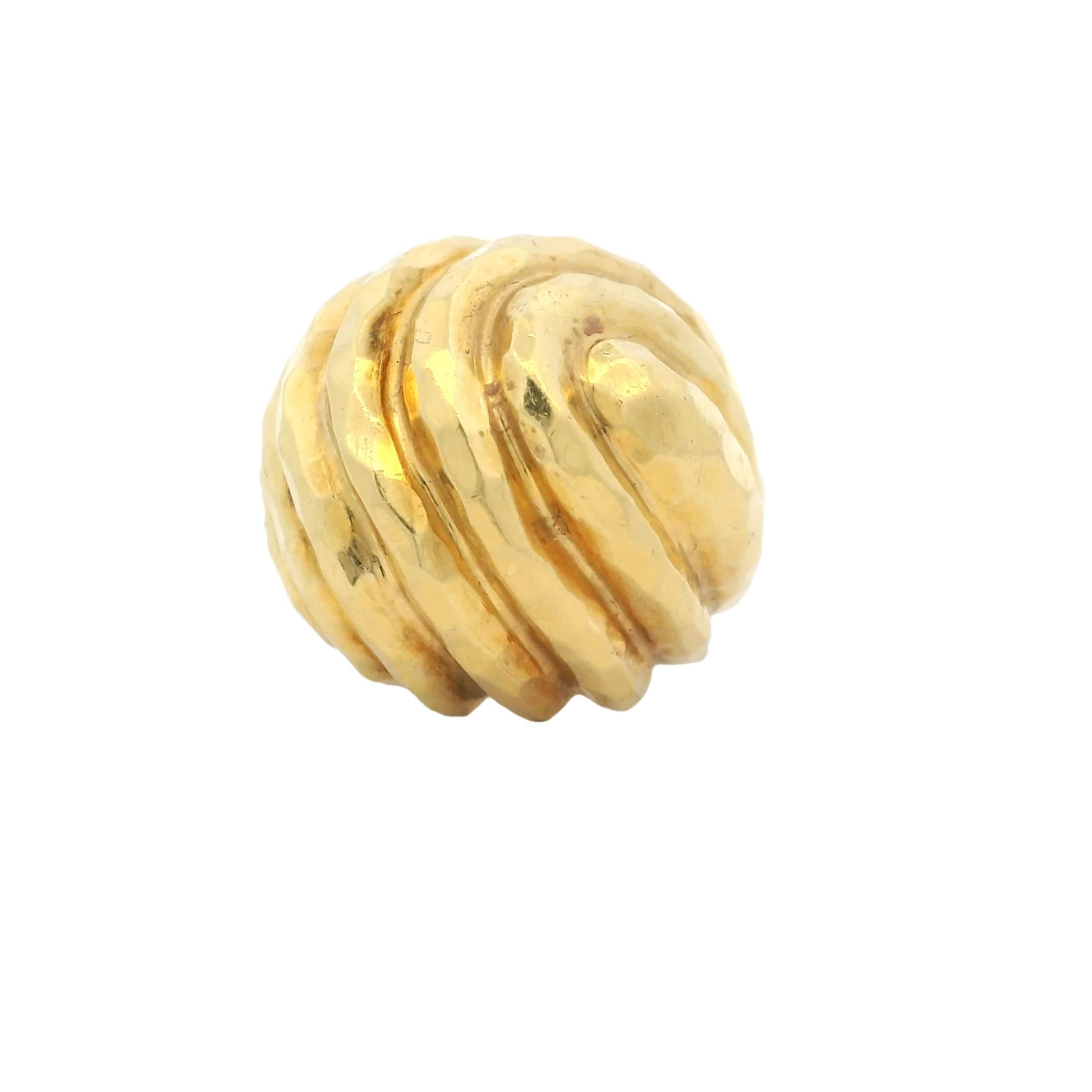 Henri Dunay’s iconic swirl dome ring showcases the designer’s masterful approach to sculptural form and texture. Crafted in 18K yellow gold, this vintage piece features his signature hand-hammered finish, creating a radiant surface that catches