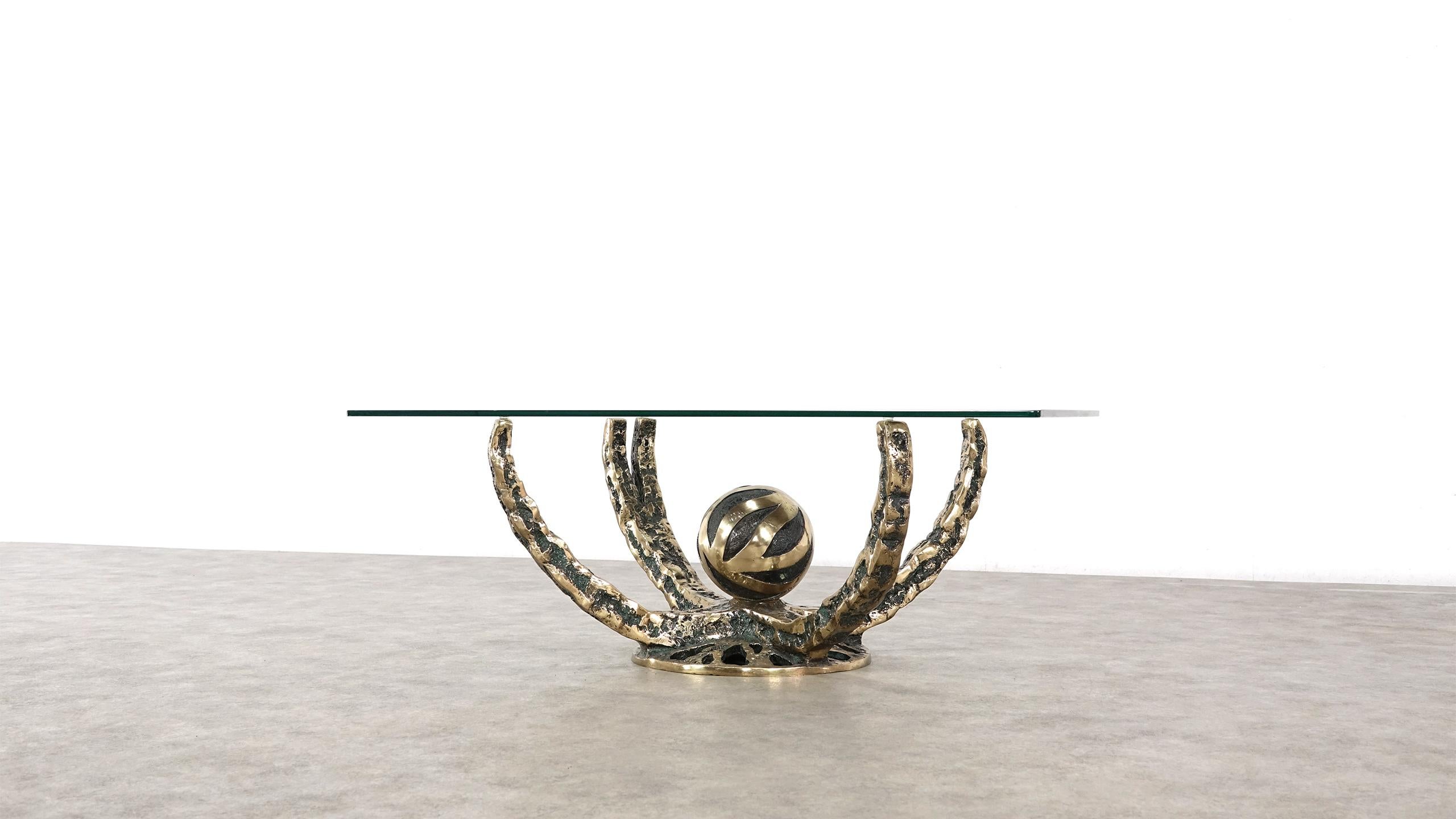 Spectacular coffee table made and designed by Henri Fernandez, France, 1972. This table has a solid bronze octopus shaped base, partly patinated in green. The square glass top has a facet edge and is in very good condition. The table is very nicely