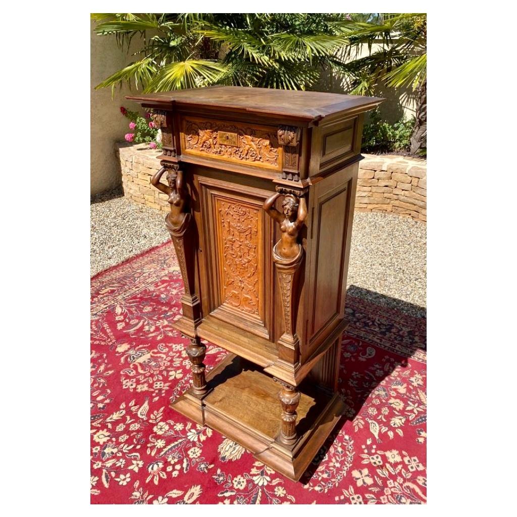 Renaissance style carved walnut cabinet or sideboard. The facade is decorated with a bust of a woman called 