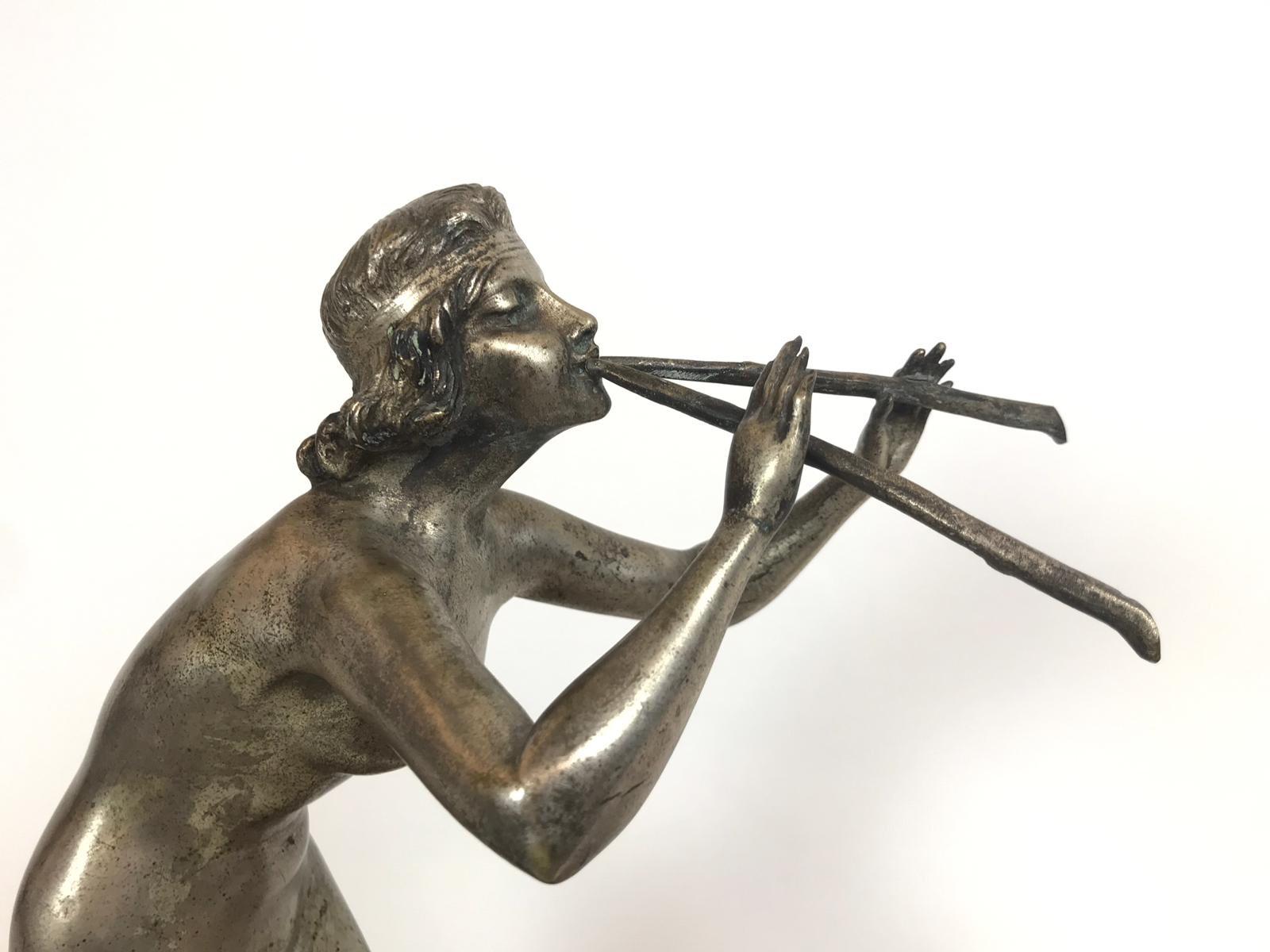 Henri Fugere (1872-1944).
A wonderful large signed Art Deco silvered bronze on marble sculpture of a nude woman playing two flutes with a dancing ram.