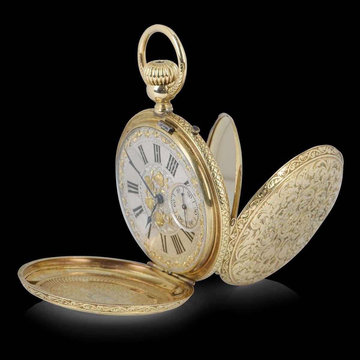 A 48 mm 18k Yellow Gold Full Hunter Vintage Gents Pocket Watch, silvered dial with a guilloche centre applied with gilt foliage, gilt foliate border, roman numerals, small seconds at 6 0'clock, blued steel hands, a fixed 18k yellow gold bezel, an