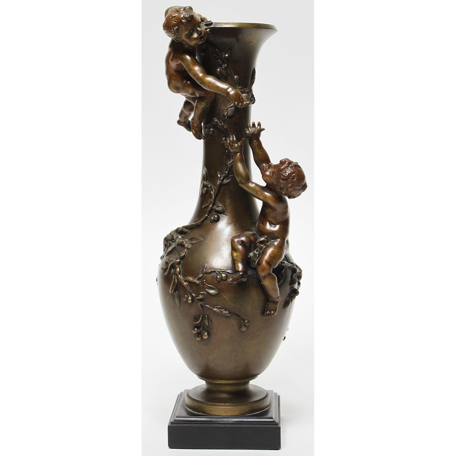 Henri-Honoré Plé (French, 1853-1922) a fine and charming patinated Bronze group of a two young boys climbing on a vase with cherry blossoms vines. The finely executed bronze group depicting two semi-naked infant boys climbing atop a bottle-shaped