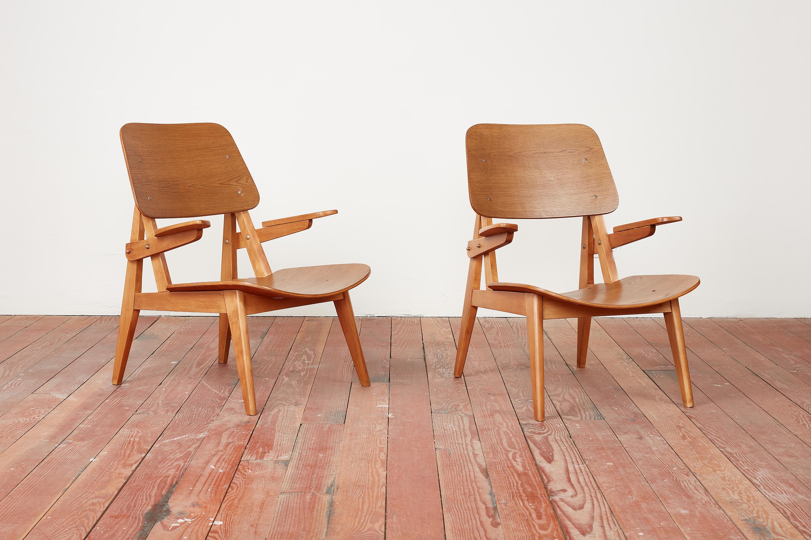 Pair of chairs by Henri Lancel for Cité University d'Antony 
France, circa 1956
Constructed of beech legs and ash plywood seat and back
Newly restored / refinished 
Wonderful angular shape and craftsmanship 
From the collection of Academy of