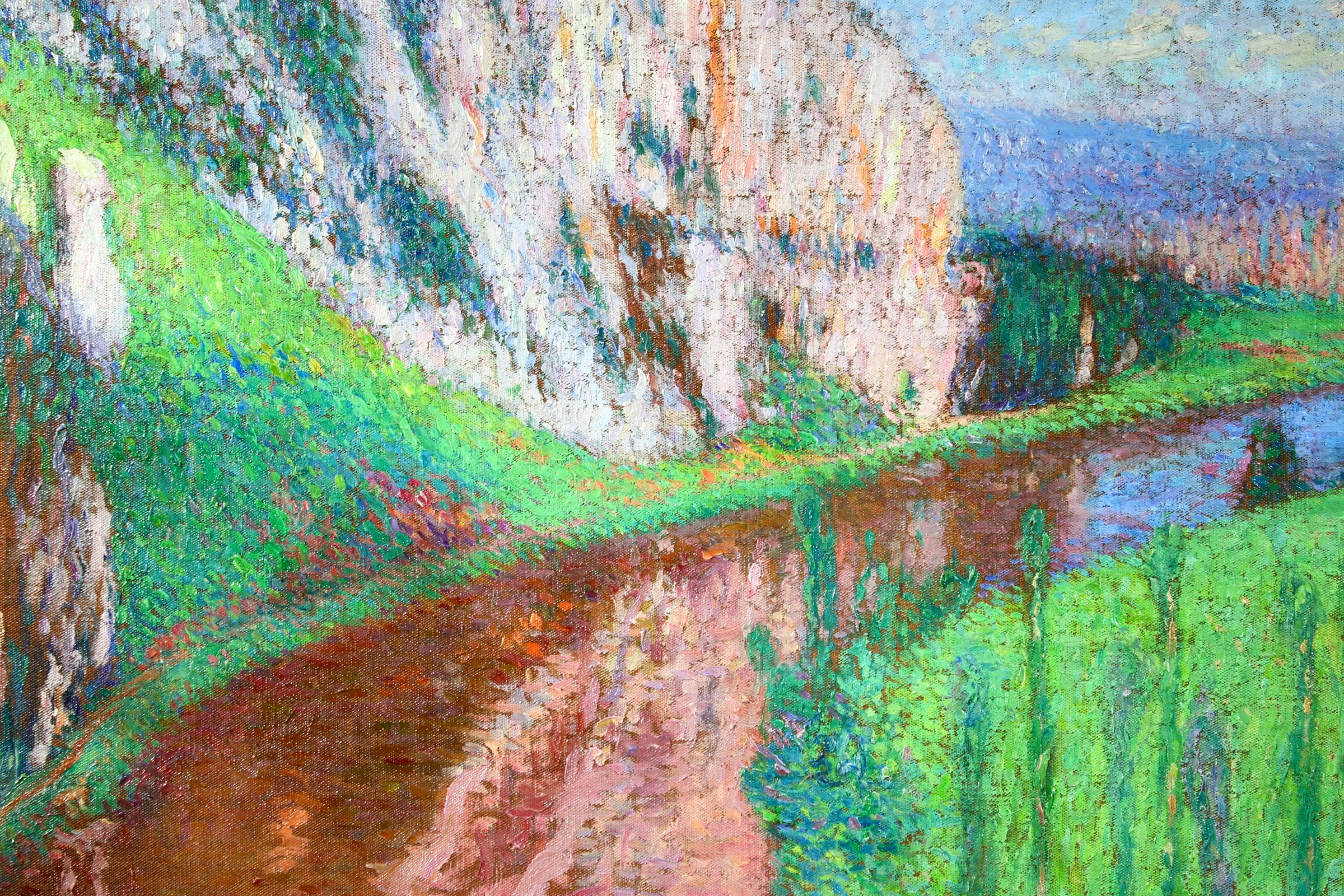 A breathtaking pointillist oil on canvas circa 1930 by Henri Martin depicting a landscape with a river flowing below the Cliffs of Saint Cirq Lapopie in South-West France. Signed lower right.

The authenticity of this work has been confirmed by
