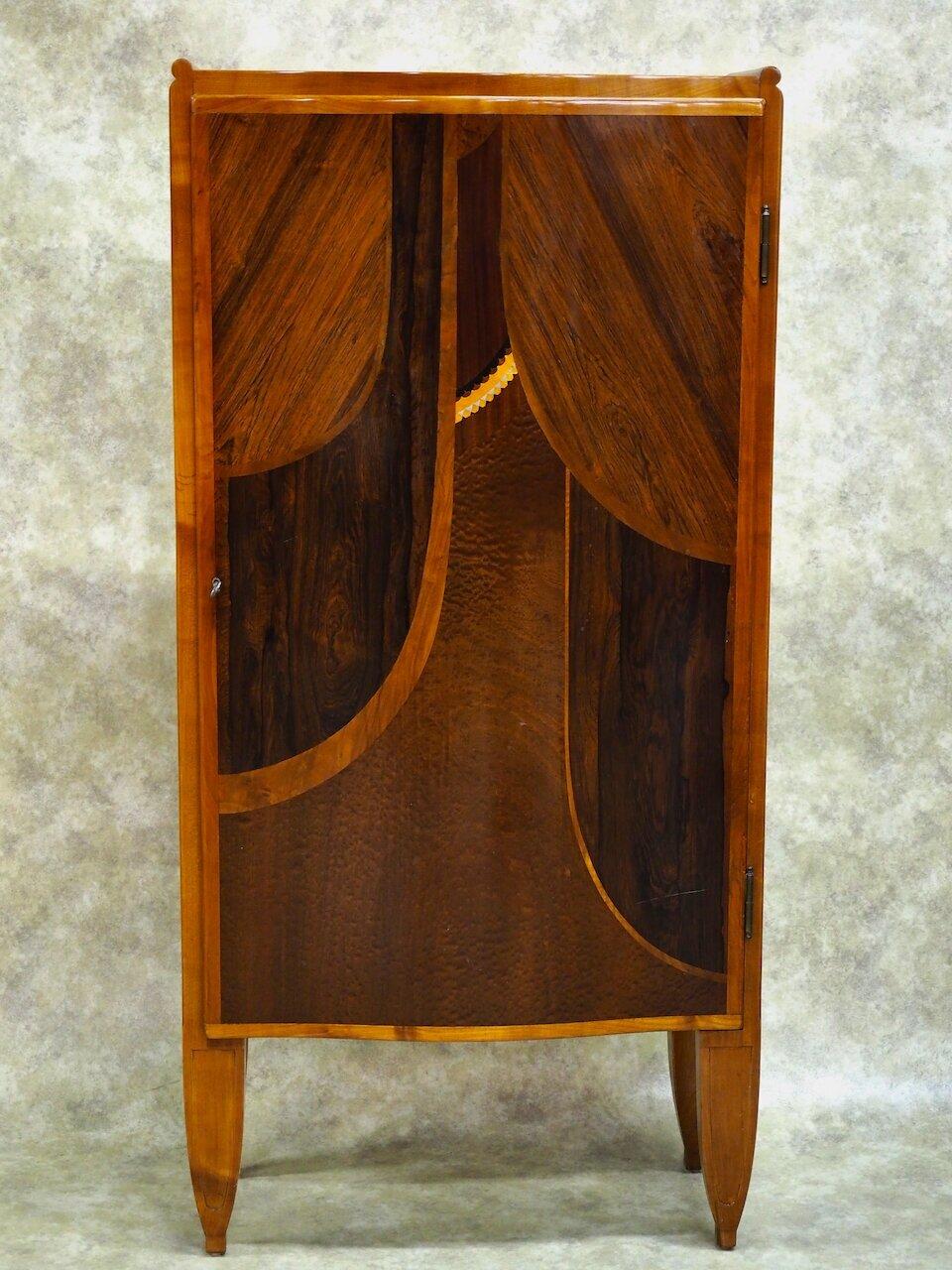 Classic French Art Deco cabinet by Henri Rapin, 1925, in cherry, rosewood, burled mahogany, ebony, and silvered metal. Finished interior with shelves. 31.5