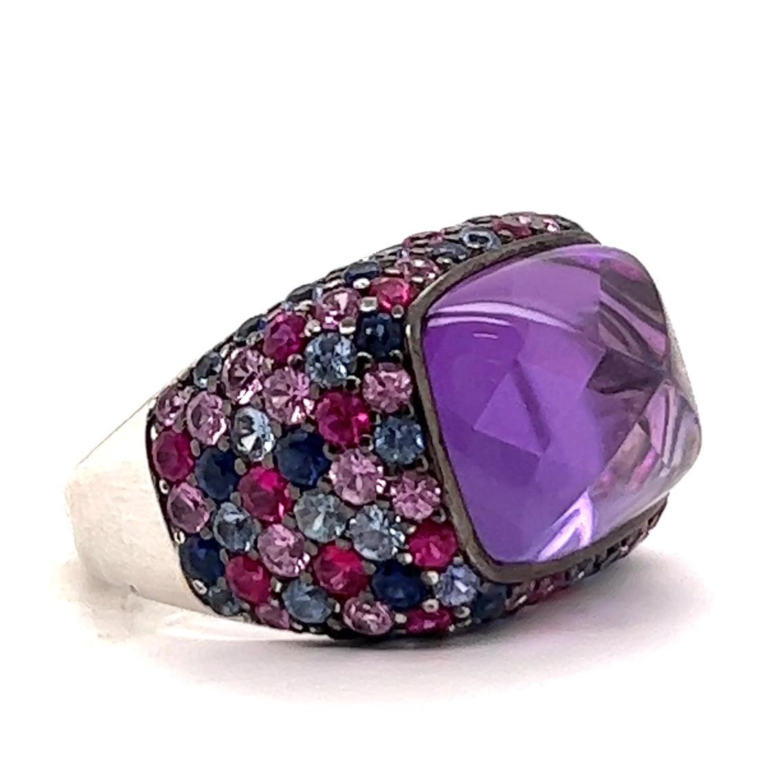 One Henri Sillam Amethyst Sapphire White Gold Cocktail Ring. Featuring one fancy cut amethyst of 11.27 carats. Accented by 54 round pink sapphires with a total weight of 2.65 carats, and 54 round blue sapphires with a total weight of 2.60 carats.