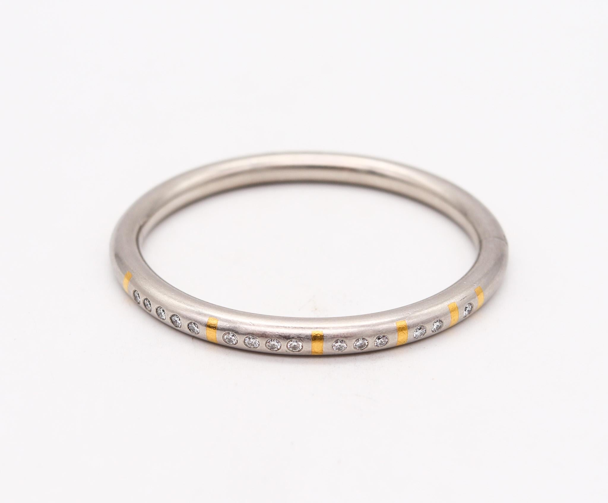 Platinum and gold bangle designed by Henrich & Denzel.

Very modern, sleek and contemporary tubular round bracelet, created by the German-Swiss jewelry designers of Henrich & Denzel. This gorgeous bangle bracelet has been manufactured with