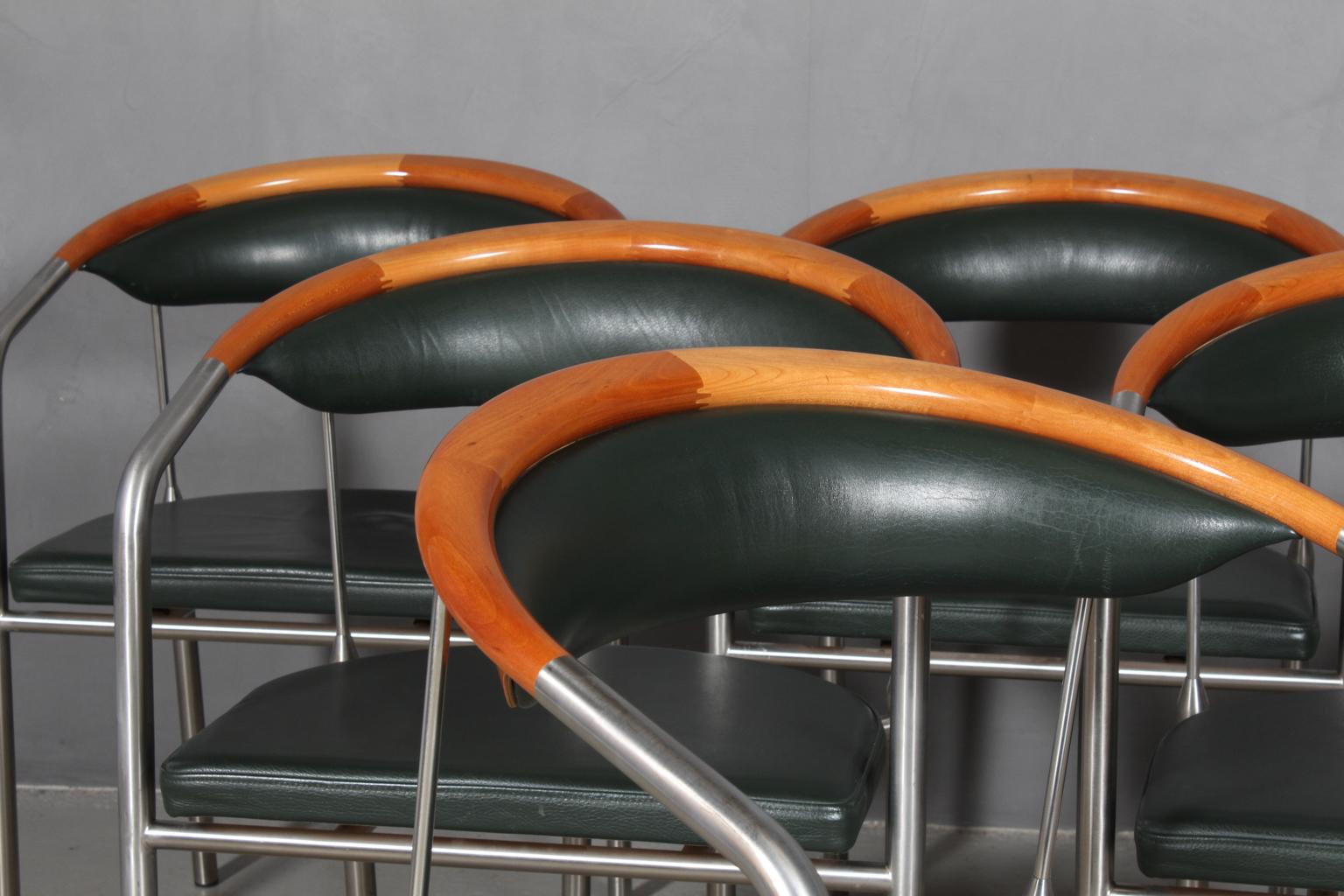Henrik Tengler armchairs in steel and backrest of cherry.

Upholstered with racing green leather.

Made by Hansen & Sørensen.