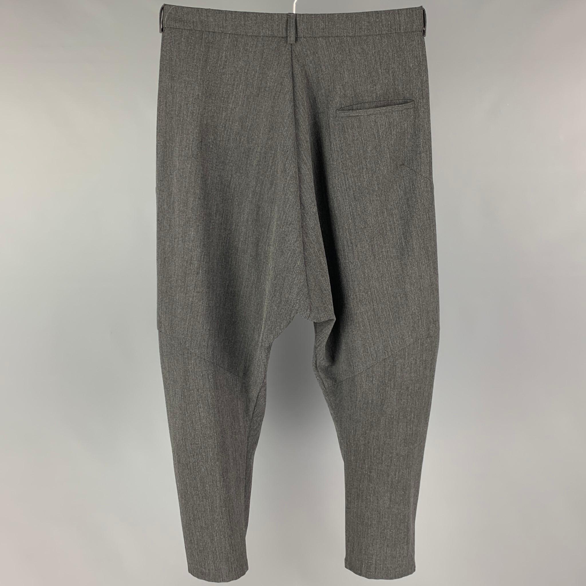 HENRIK VIBSKOV dress pants comes in a gray polyester featuring a pleated style, drop-crotch, and a zip fly closure. Made in Portugal. 

Very Good Pre-Owned Condition.
Marked: M

Measurements:

Waist: 32 in.
Rise: 18.5 in.
Inseam: 23 in. 