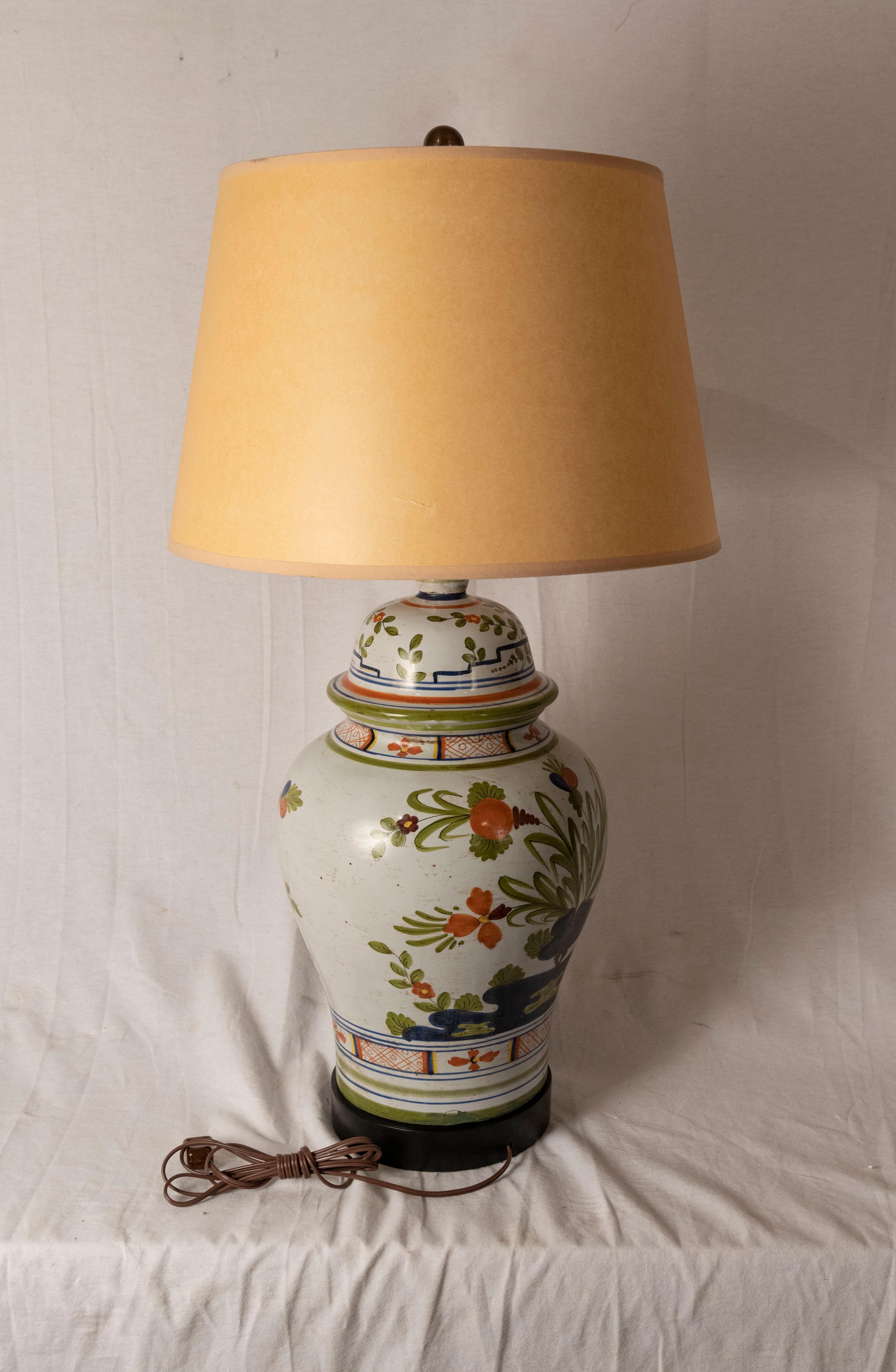 Henriot Quimper-style Faience Ginger Jar Lamp. A 19th century faience leaf and floral decorated lidded ginger jar in the style of Henriot Quimper French pottery, fitted as a lamp.

Measures: 33 x 17 diameter inches.