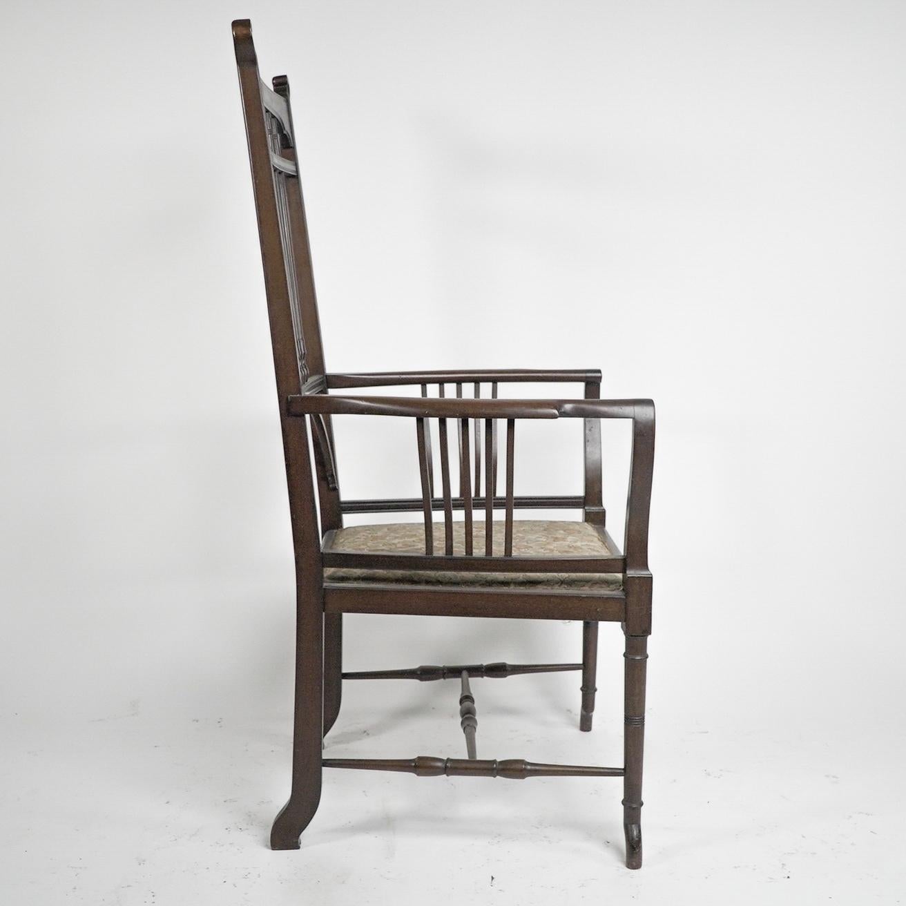 English Henry W Batley attr. An Aesthetic Movement walnut armchair with sinuous touches. For Sale