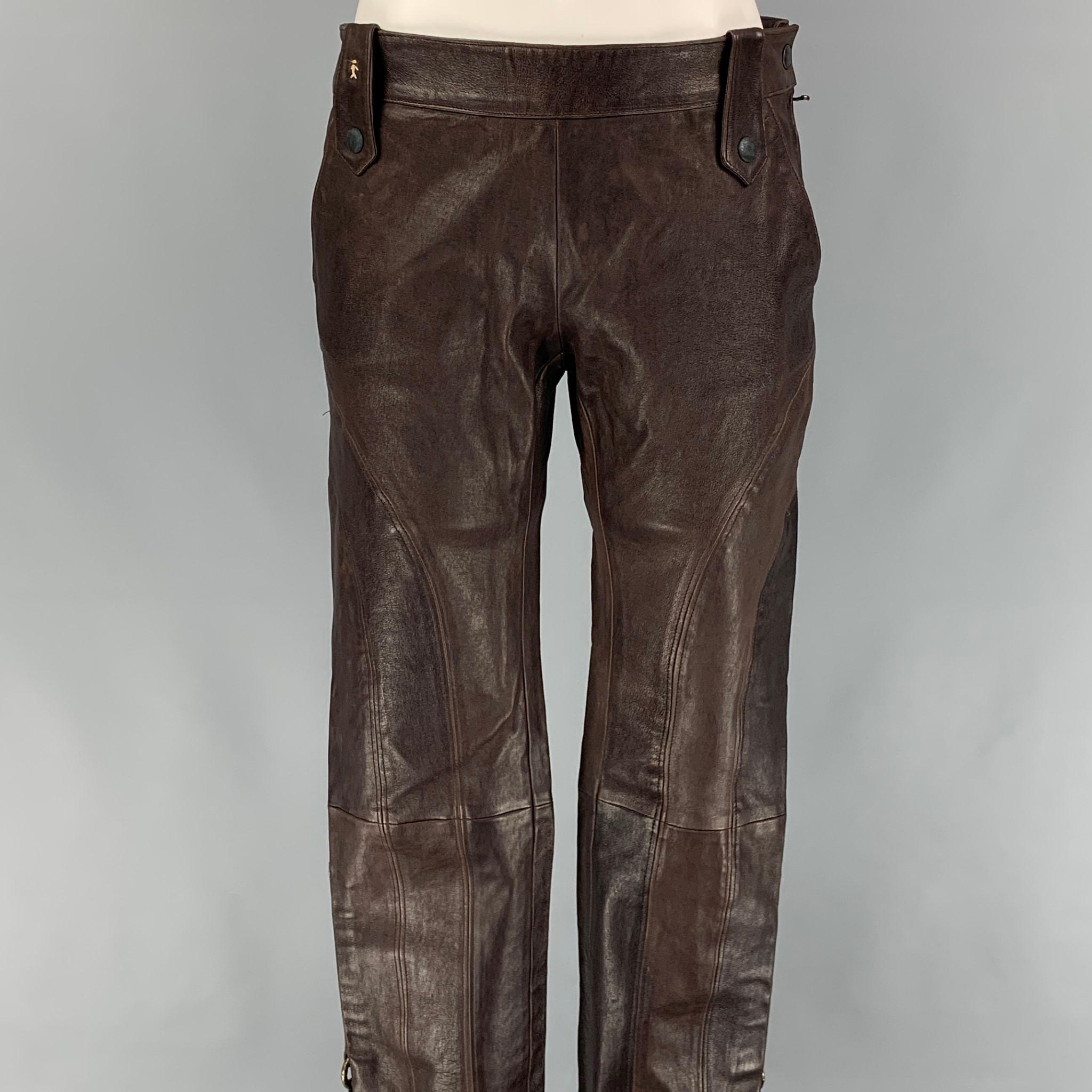 HENRY BEGUELIN dress pants comes in a brown leather featuring top stitching, snap button details, leg strap details, and a side zipper closure. Made in Italy. 

Very Good Pre-Owned Condition.
Marked: 42

Measurements:

Waist: 30 in.
Rise: 8.5