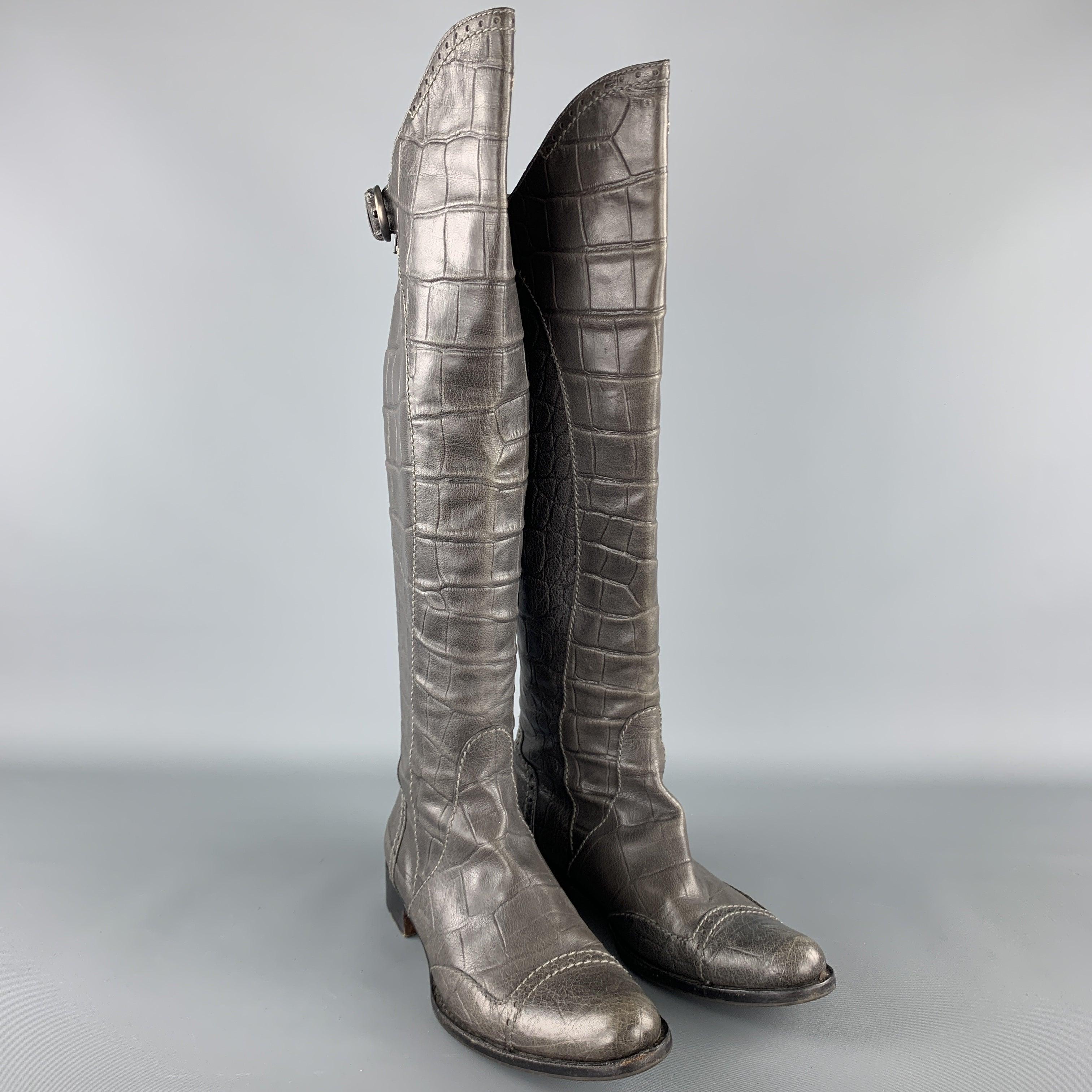HENRY BEGUELIN boots come in grey crocodile embossed leather with a pointed cap toe, knee high shaft, and back zip closure with strap. Handmade in Italy.Very Good
Pre-Owned Condition. 

Marked:   IT 38.5Outsole: 11 x 3.75 inches Length: 16.5-20