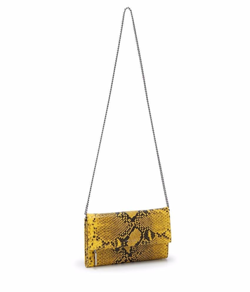 Henry Bendel Girls Night Out Embossed Snake Clutch Bag
 
 - Black and Yellow Clutch Bag
 - Embossed snake print effect
 - Leather
 - Flap front with magnetic closure
 - Flap has zip compartment
 - 2 internal compartments, 1 zip compartment, 8 card
