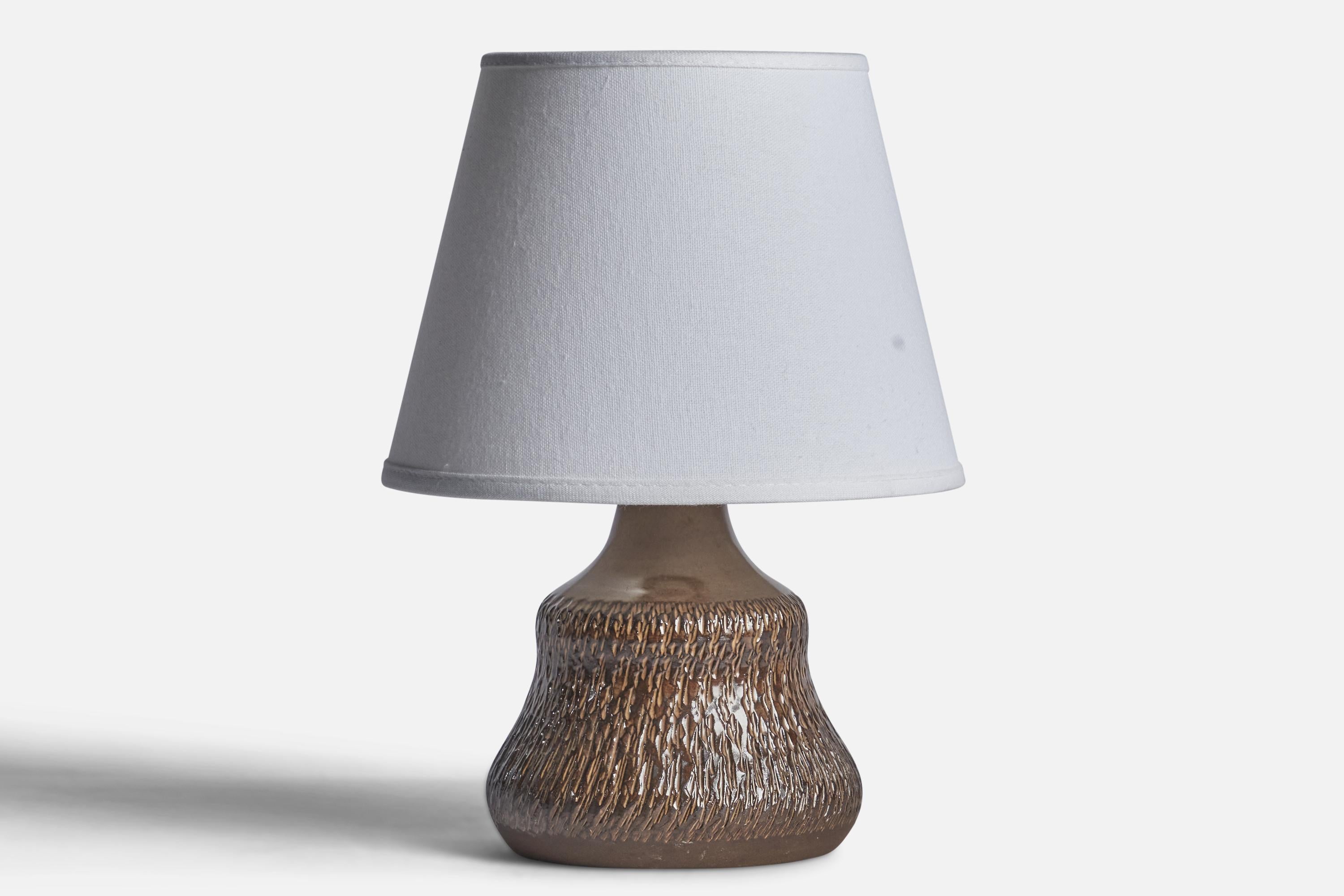 A small brown-glazed stoneware table lamp designed and produced by Henry Brandi, Vejbystrand, Sweden, c. 1960s.

Dimensions of Lamp (inches): 8.5” H x 5.25” Diameter
Dimensions of Shade (inches): 5” Top Diameter x 8” Bottom Diameter x 6” H