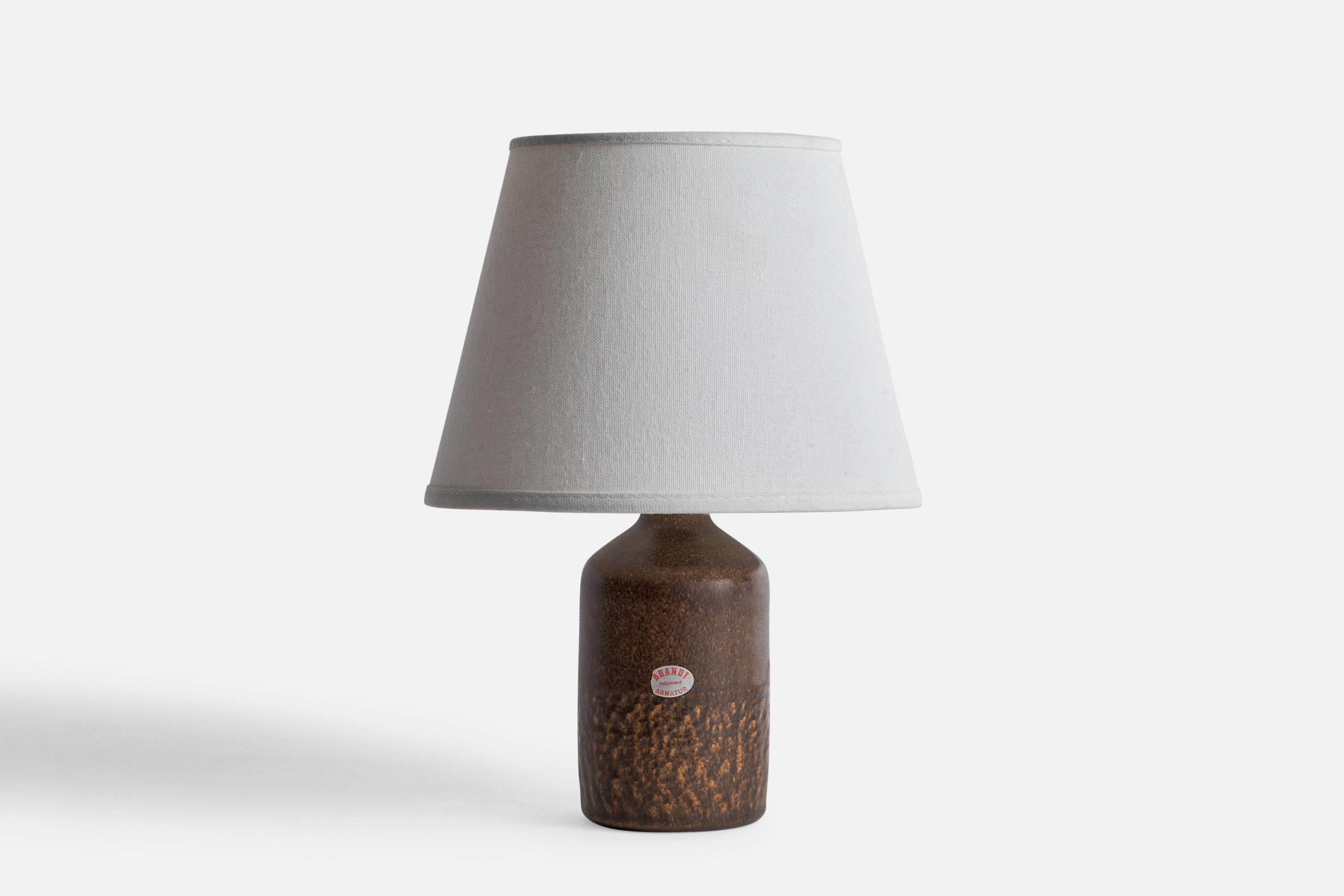 A brown-glazed table lamp designed and produced by Henry Brandi, Vejbystrand, Sweden, 1960s.

Dimensions of Lamp (inches): 8” H x 3.1” Diameter
Dimensions of Shade (inches): 3” Top Diameter x 5.75” Bottom Diameter x 4.5” H
Dimensions of Lamp with