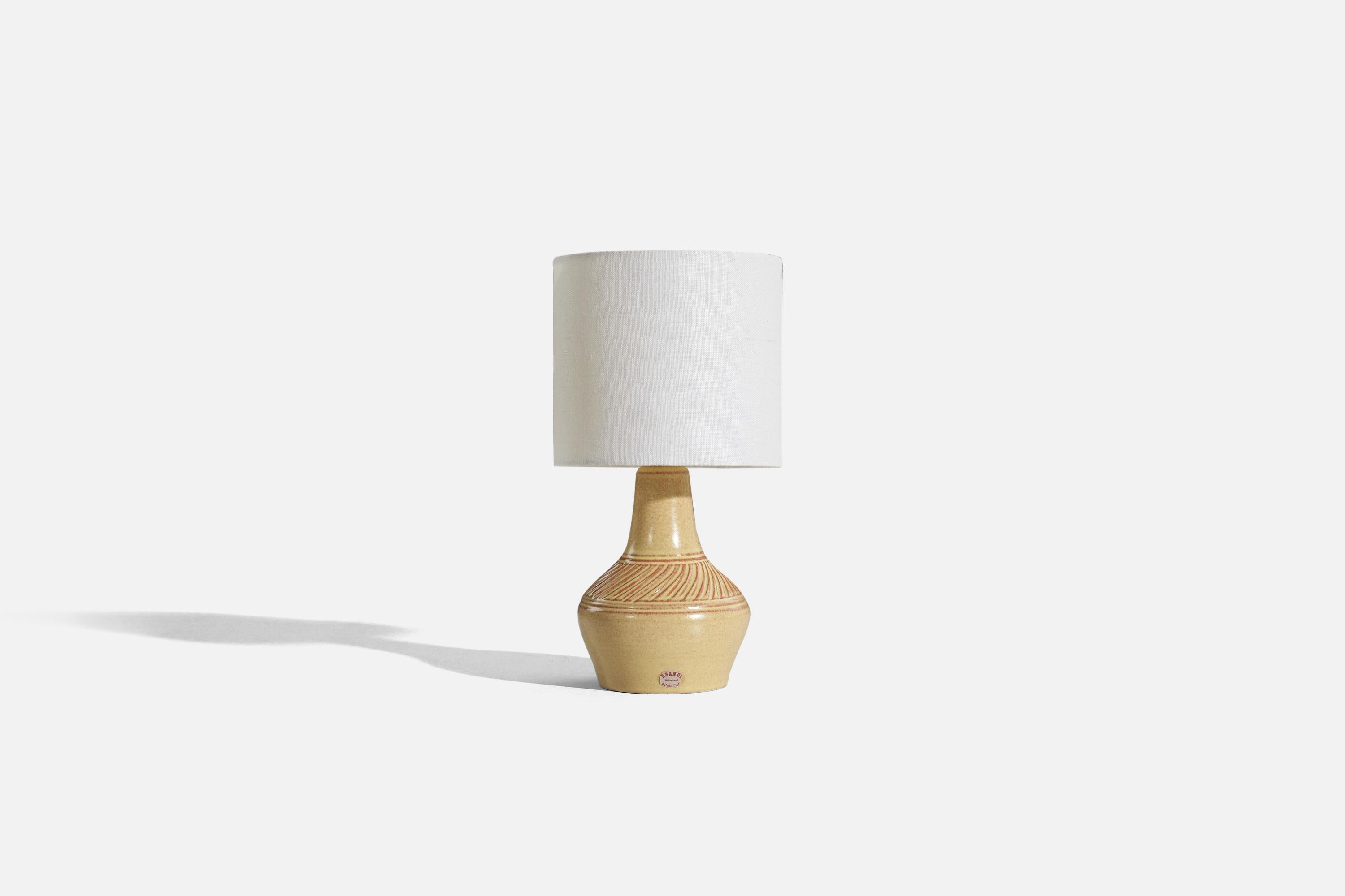 A cream-glazed stoneware table lamp designed by Henry Brandi and produced by his own firm, Brandi Vejbystrand, Sweden, 1960s. 

Sold without lampshade. 
Dimensions of Lamp (inches) : 8.1875 x 4.5 x 4.5 (H x W x D)
Dimensions of Shade (inches) : 6 x