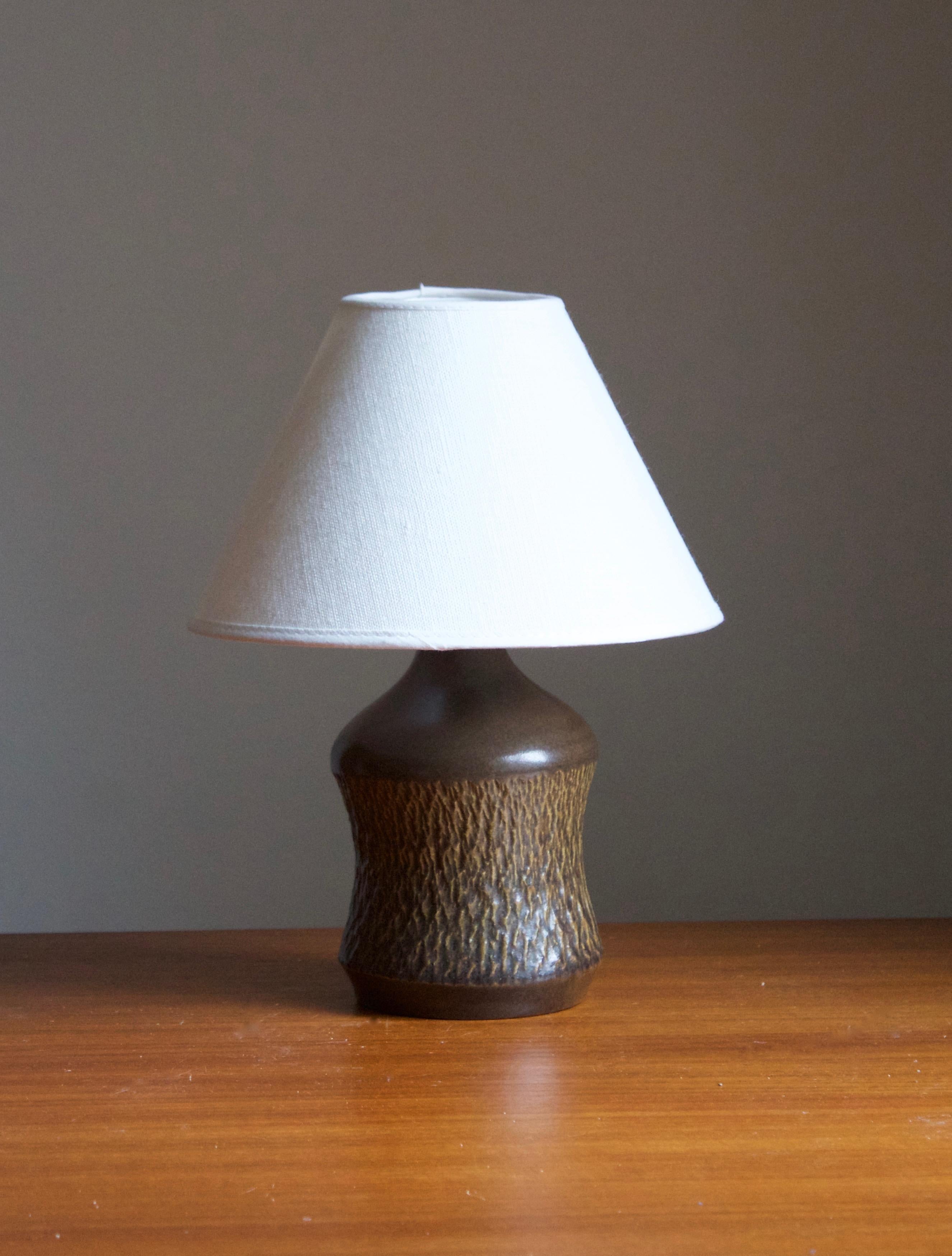 A stoneware table lamp designed by Henry Brandi, and produced by his own firm, Brandi Vejbystrand, Sweden, 1960s. Marked and labeled. 

Stated dimensions exclude lamsphade. Height includes socket. Shade is not included in purchase.

Glaze features a