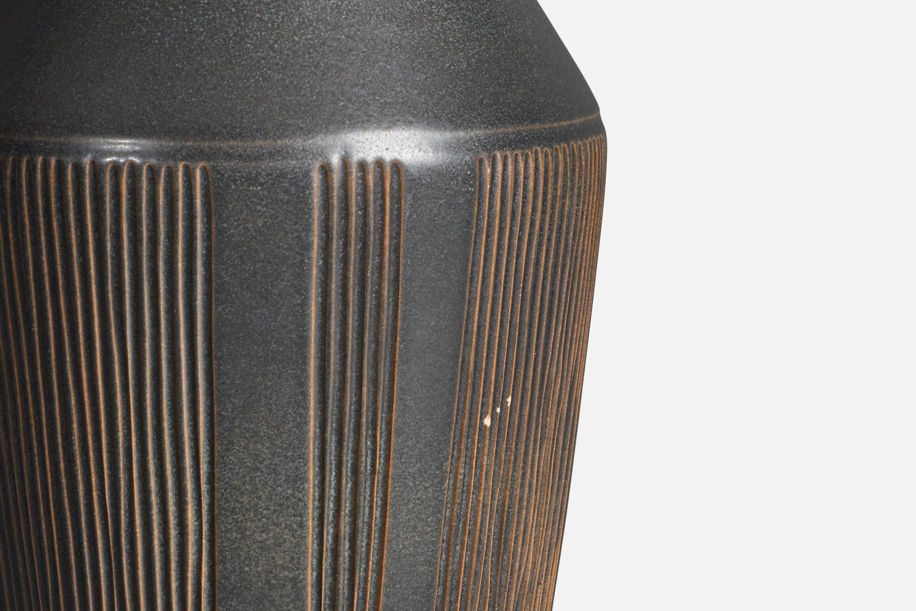 A sizable organic stoneware table lamp designed by Henry Brandi, and produced by his own firm, Brandi Vejbystrand, Sweden, 1960s. Marked and labeled. 
Other lighting designers of the period include Bendt Friberg, Paavo Tynell, Alvar Aalto, Hans