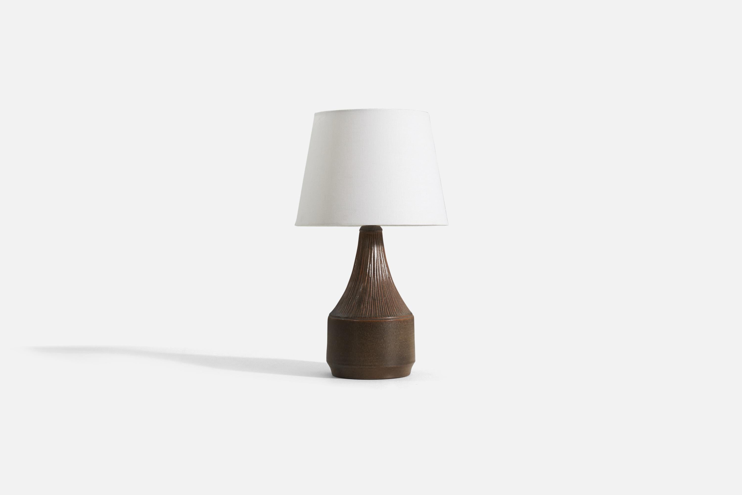 A brown stoneware table lamp designed by Henry Brandi, and produced by his own firm, Brandi Vejbystrand, Sweden, 1960s. Marked and labeled. 

Sold without shade. Measurements listed are of lamp itself. 

For reference. additional dimensions