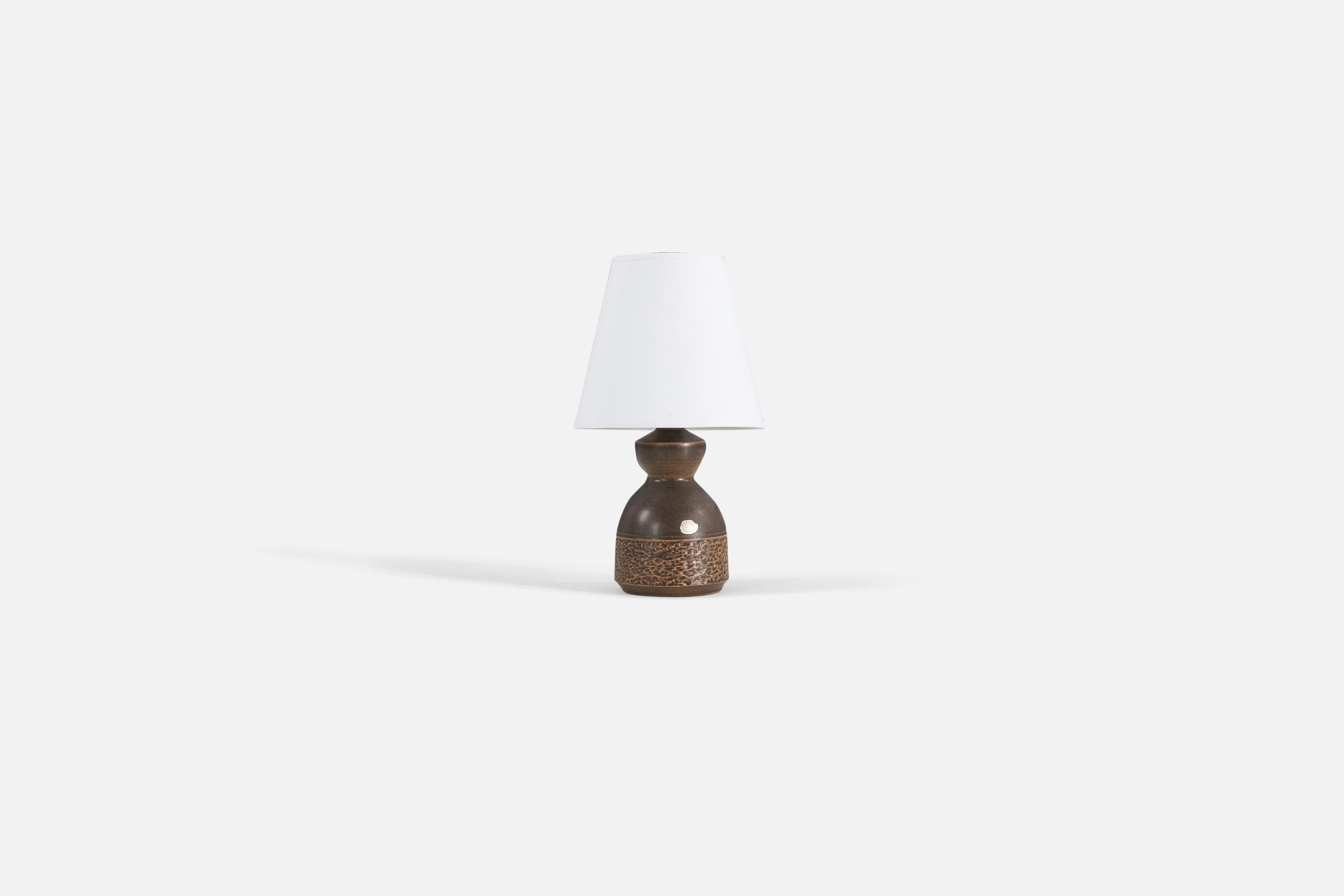 A brown stoneware table lamp designed by Henry Brandi, and produced by his own firm, Brandi Vejbystrand, Sweden, 1960s. Marked and labeled. 

Sold without lampshade. 

Measurements listed are of lamp.
Shade : 4 x 7 x 6.25 
Lamp with shade : 12