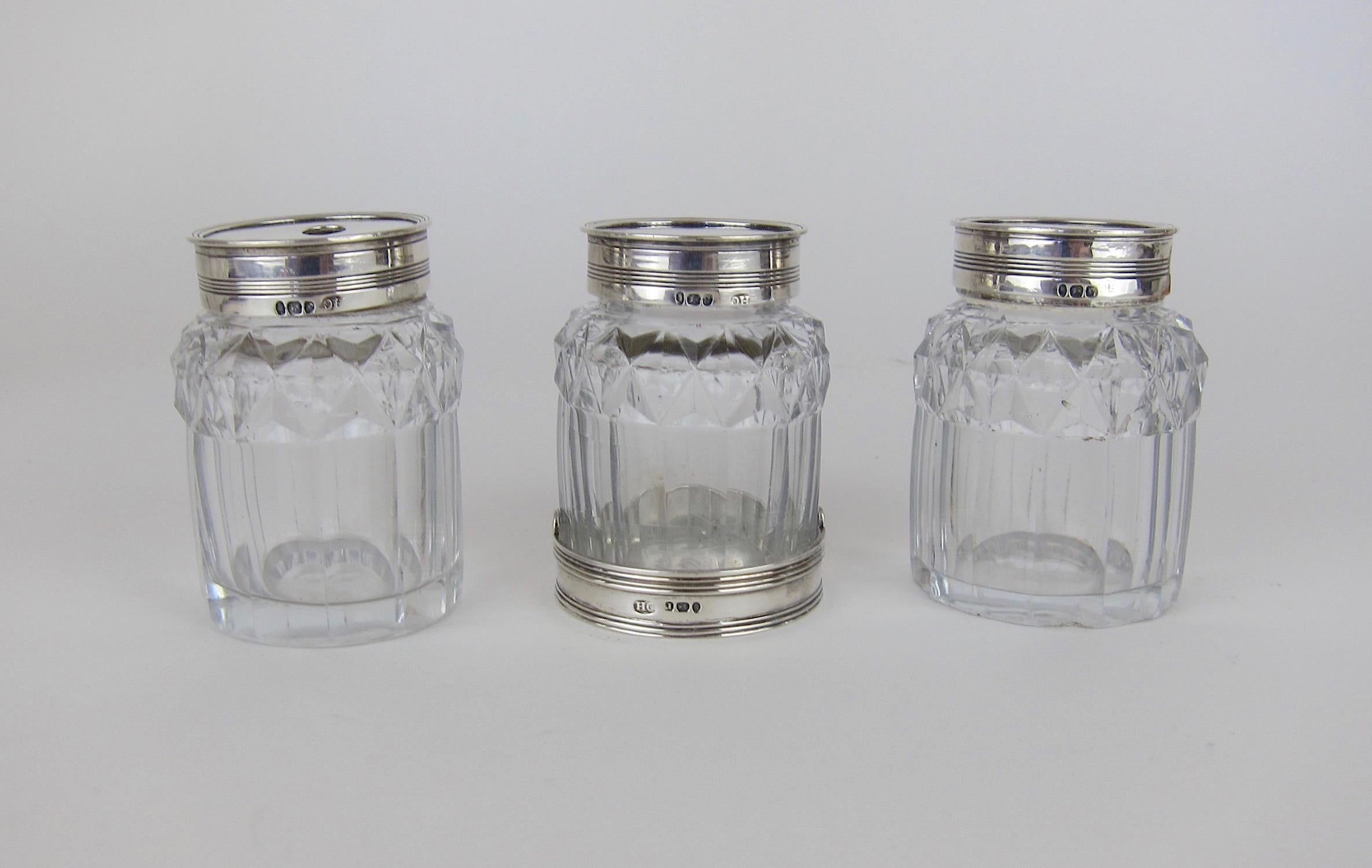 A set of three George III cut-glass bottles with sterling silver lids, made by English silversmith Henry Chawner of London and hallmarked for 1792. The antique set comes from The collection of Peggy and David Rockefeller. 

The 18th century jars