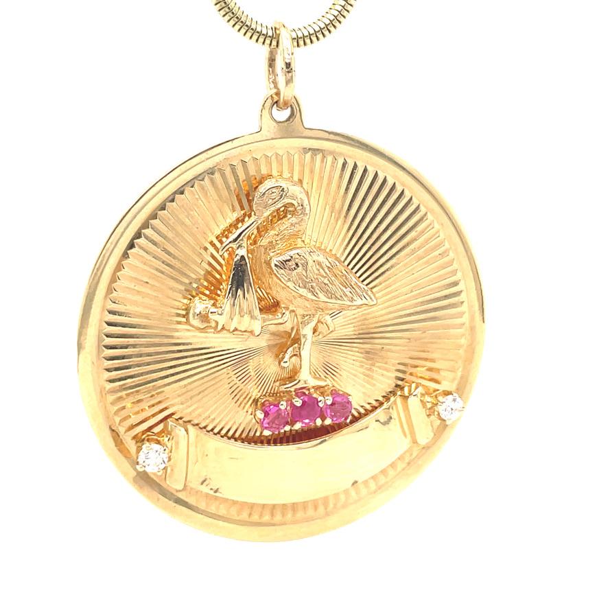 Large circular disc with radiating line pattern.  Applied in the center is a figural stork, carrying a baby in a blanket, perched on three faceted rubies.  Underneath is an applied banner which can be engraved with a name and date.  The banner is