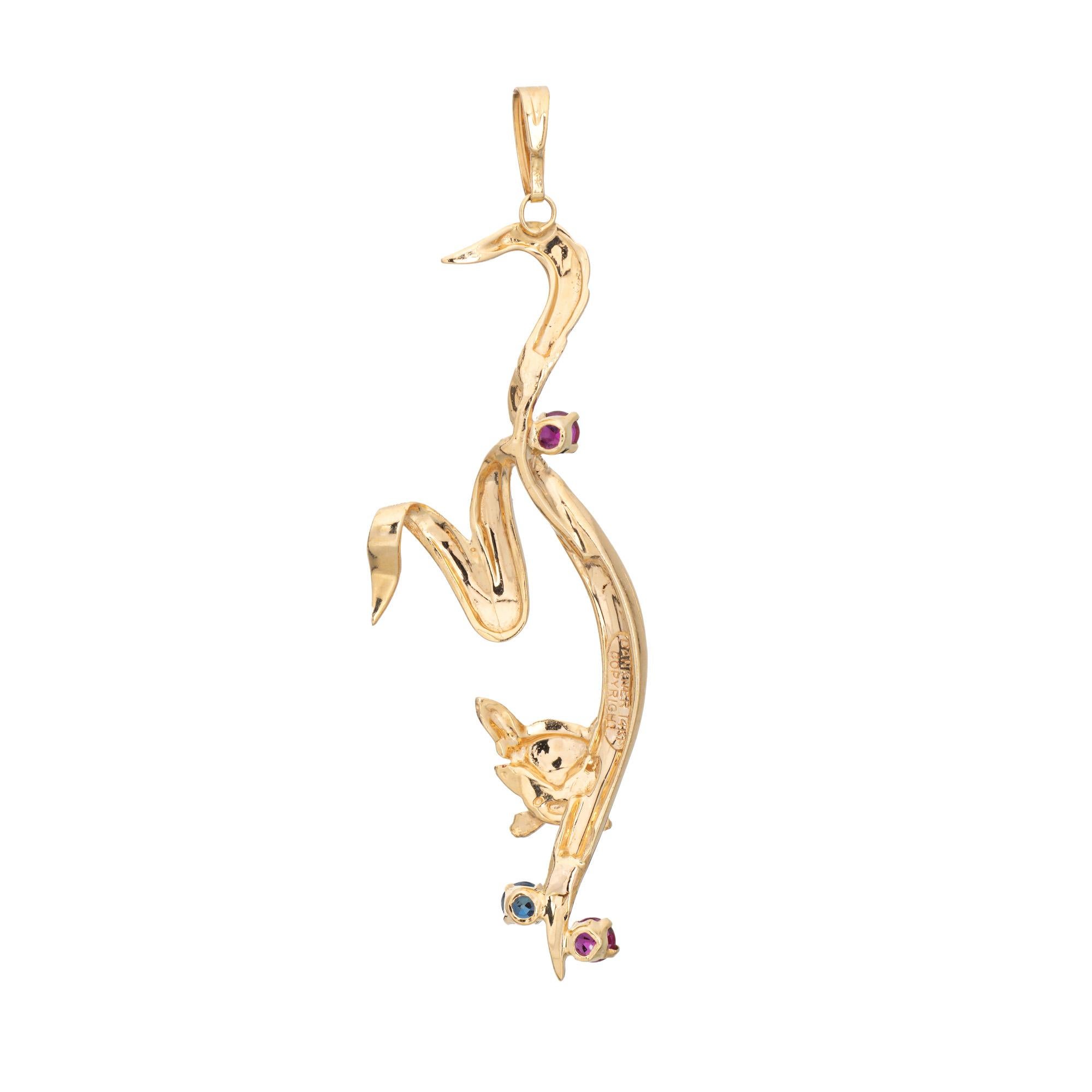 Finely detailed vintage Dankner cat pendant crafted in 14k yellow gold (circa 1960s to 1970s).  

Two rubies measure approx. 3mm each, one sapphire measures approx. 3mm. The gemstones are in very good condition and free of cracks or chips.  

The