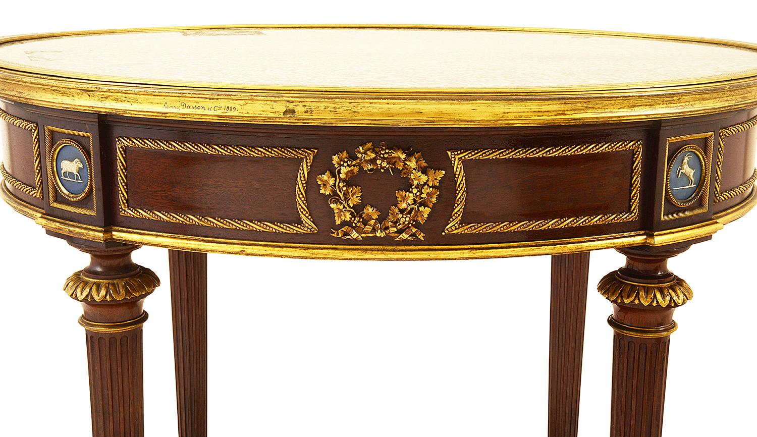 Fine quality late 19th Century marble topped Gueridon, with gilded ormolu mouldings and mounts, inset classical Wedgwood plaques, raised on turned tapering legs, united by a galleried under tier.
By Henry Dasson
Henry Dasson was a renowned