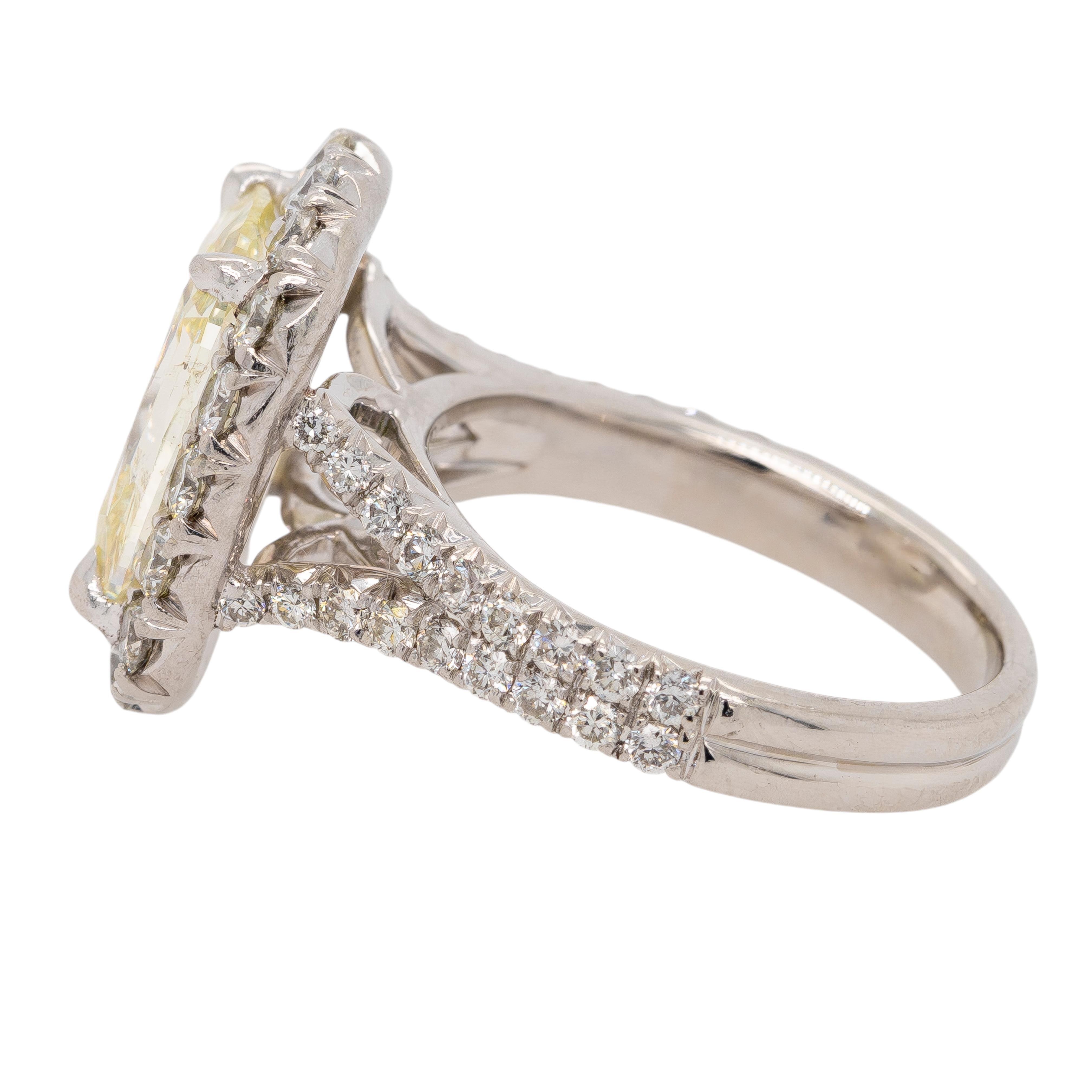 This stunning Henry Daussi Platinum Ring features a striking 3.59-carat Cushion Cut Diamond at its center, with a L color and SI1 clarity, offering a brilliant, captivating presence. Surrounding the center stone are approximately 1.05 carats total